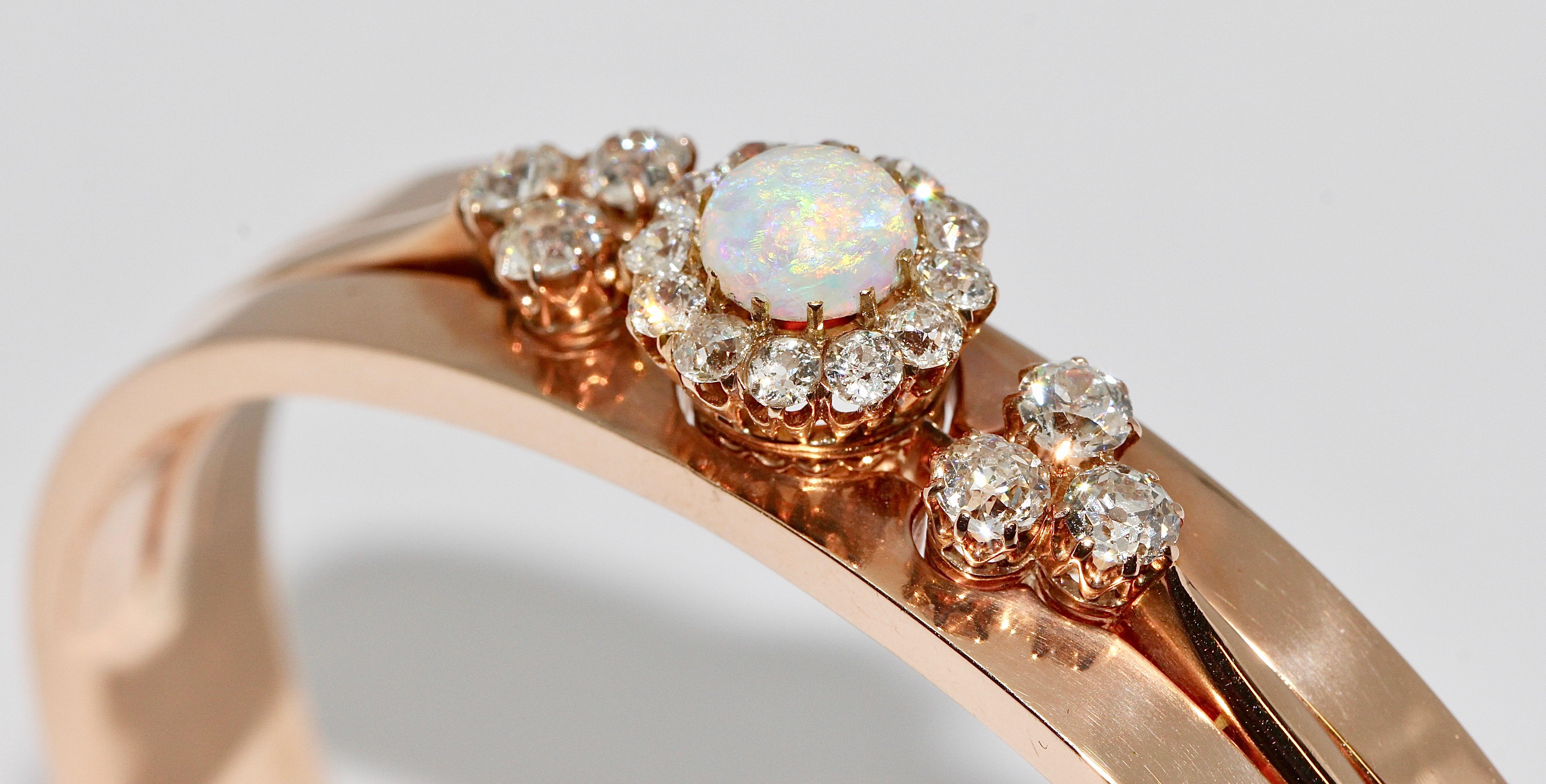 Antique ladies bangle with precious opal and diamonds. 14 Karat gold.

Magnificent ladies bangle, set with an Opal Cabouchon (slightly ripped off at one point) 

and with:

Six old cut diamonds, together about 1.07ct
12 old cut diamonds, totaling