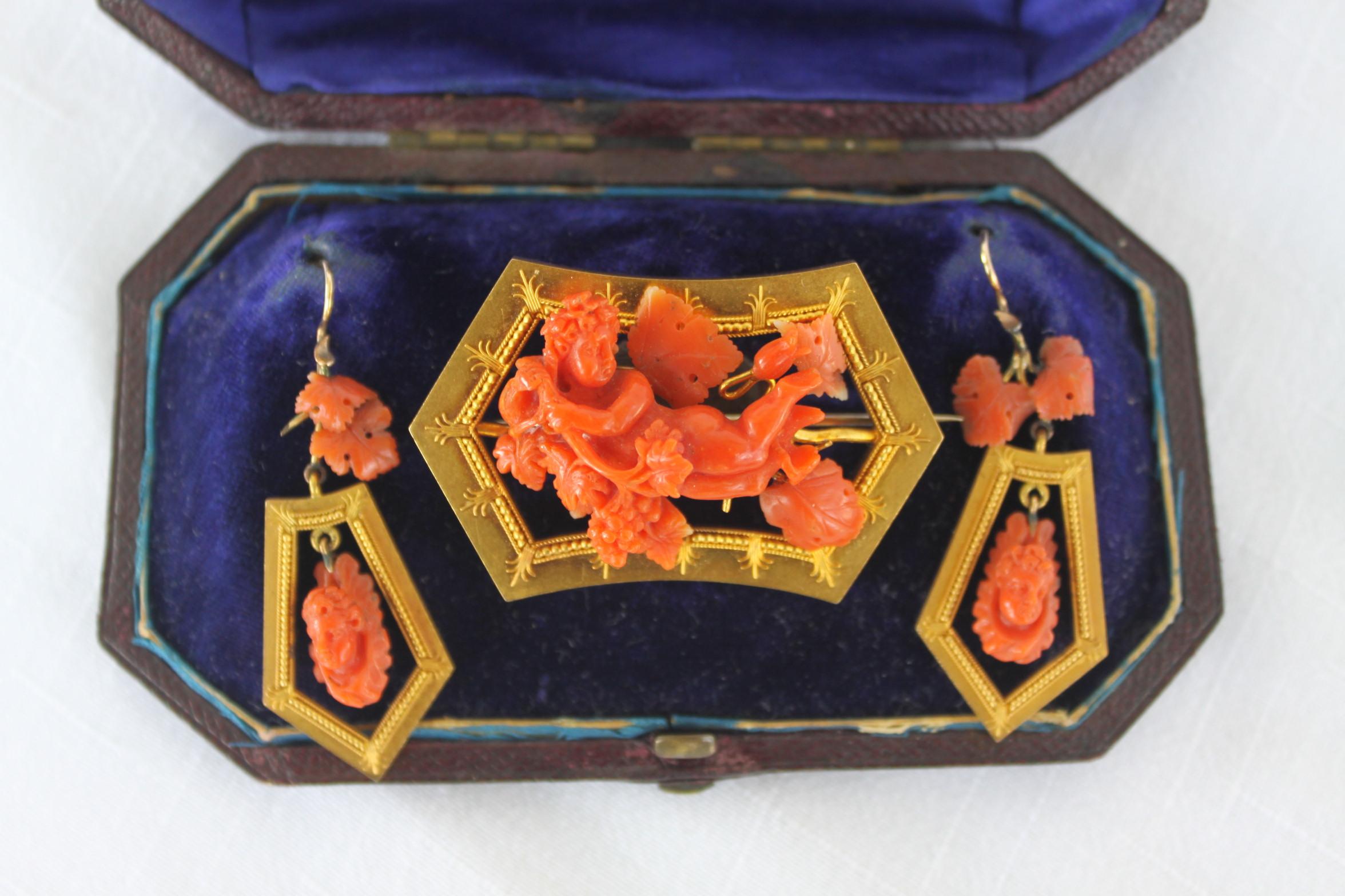 This antique demi-parure set is completely unmarked but tests for a minimum of 14-karat yellow gold and is believed to have been made in England in circa 1890 in the period Victorian style. The large brooch features a very well executed hand carved