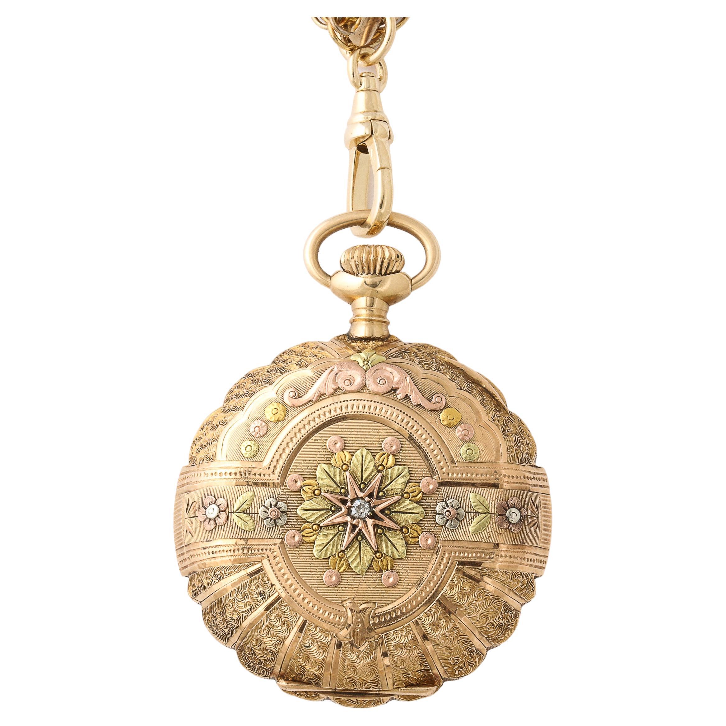 This exquisite Antique 14k four color gold hunter case pocket watch made by the Elgin Company around 1908 (based on movement serial # 13333340) features an elaborately decorated 14 carat  yellow, rose, green and white gold full hunter case, foliate
