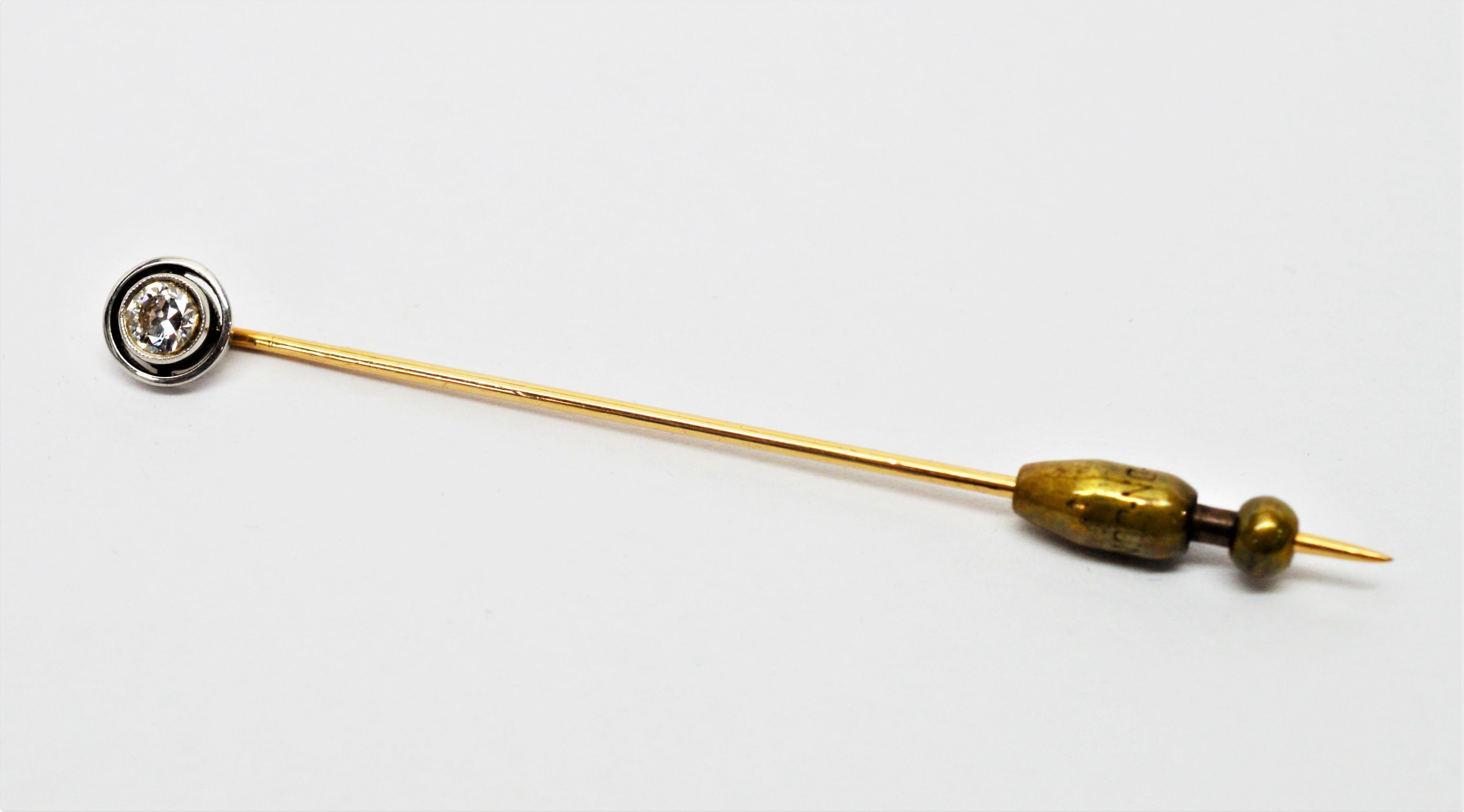 In it's original purple velvet box from Lambert Bros. New York and signed, this fourteen carat yellow gold antique stick pin with .30 carat miner's cut diamond H/VS is delicately framed in white platinum with a black enamel rim is the height of
