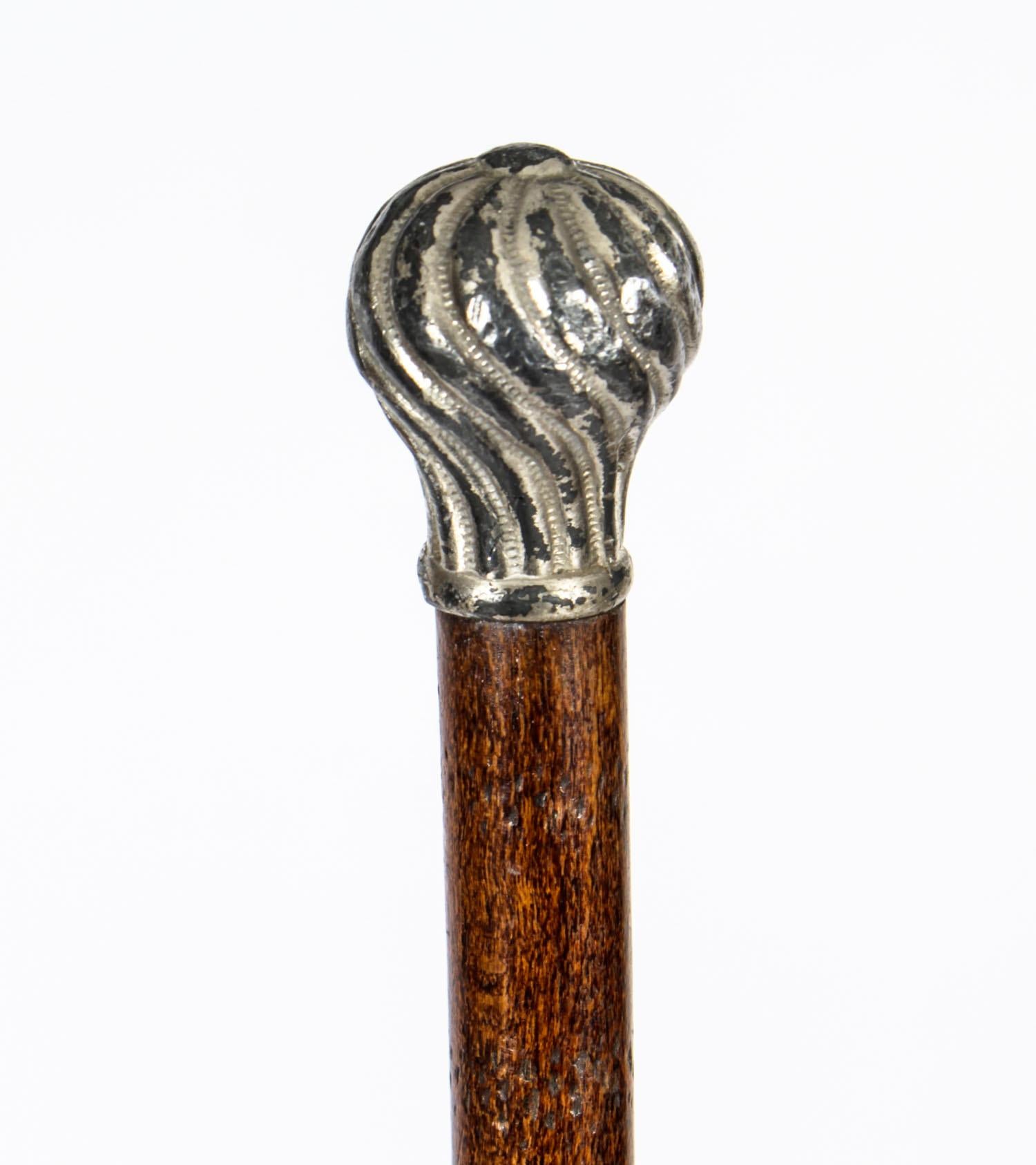 This is a lovely ladies silver plated mounted Malacca walking stick, circa 1880 in date. 
 
This decorative walking cane features a splendid globular silver plated pommel which is decorated with exquisite Rococo style above a Malacca tapering