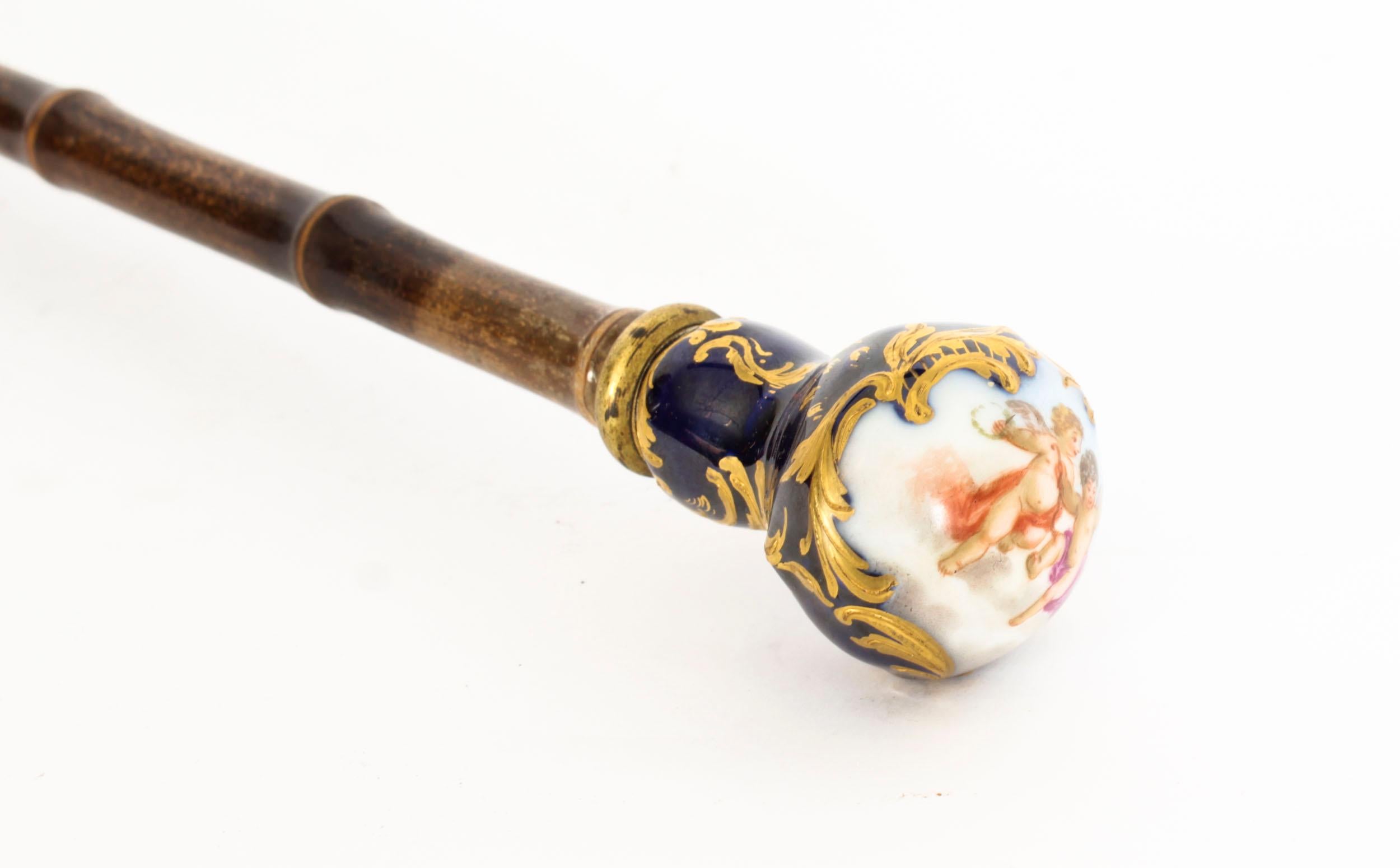 This is a beautiful antique French walking cane with hand painted porcelain spherical handle in the Sevres manner, with a bamboo  shaft, Circa 1880 in date.

The handle is beautifully decorated with a quatrefoil vignette of cherubs playing in the