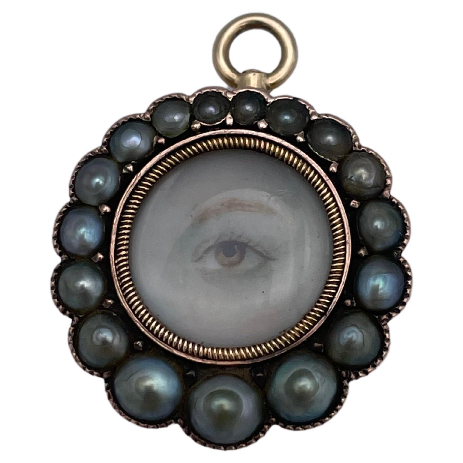 Most charming and endearing Lady's Eye miniature pendant.  Locket back.  Rose gold. Circular, with border of natural pearls.  These are all the original pearls, in graduated sizes.  Lovely clear hand-painted miniature portrait of a lady's eye, with