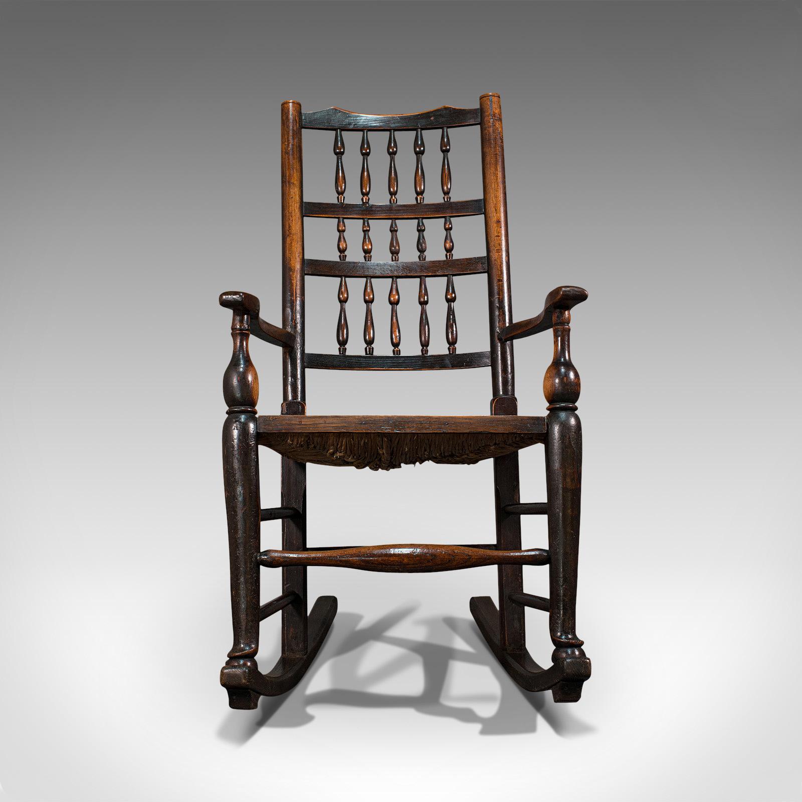 This is an antique Lancashire rocking chair. An English, ash and elm spindle back seat, dating to the Georgian period and later, circa 1800.

Wonderful country-house appeal
Displays a desirable aged patina throughout
Ash and elm offer fine grain