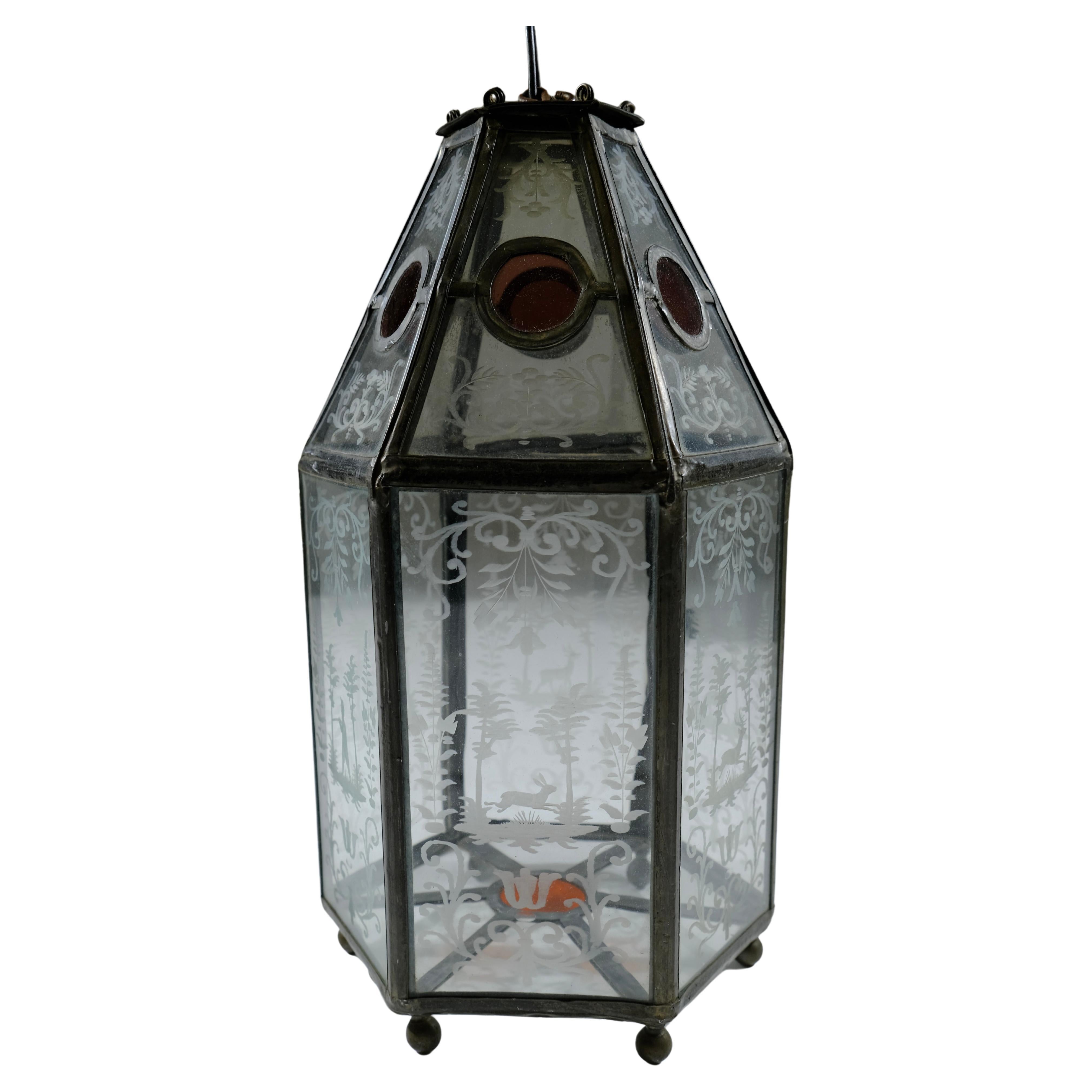  A unusual lantern from the 19th c. The frame is made of lead and the glass-plates have engraved motives of different animals and a hunter. Its unusual to find a lantern like this where all glass is whole and not cracked.