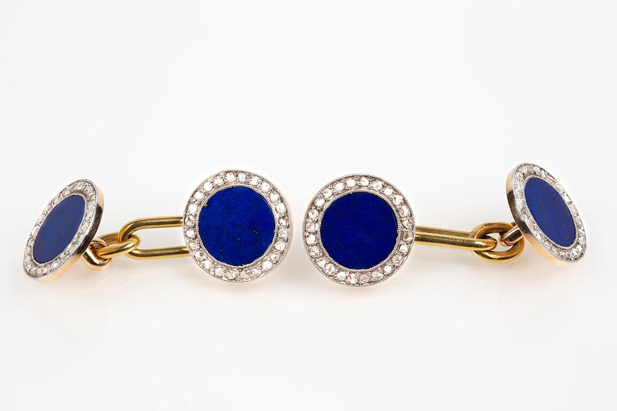 A fine and bright quality pair of antique double sided cufflinks with a natural lapis lazuli centre. Circular in shape with a border of rose cut diamonds set in platinum and mounted in 18 carat yellow gold. Oval bar connection.
Measures 12mm