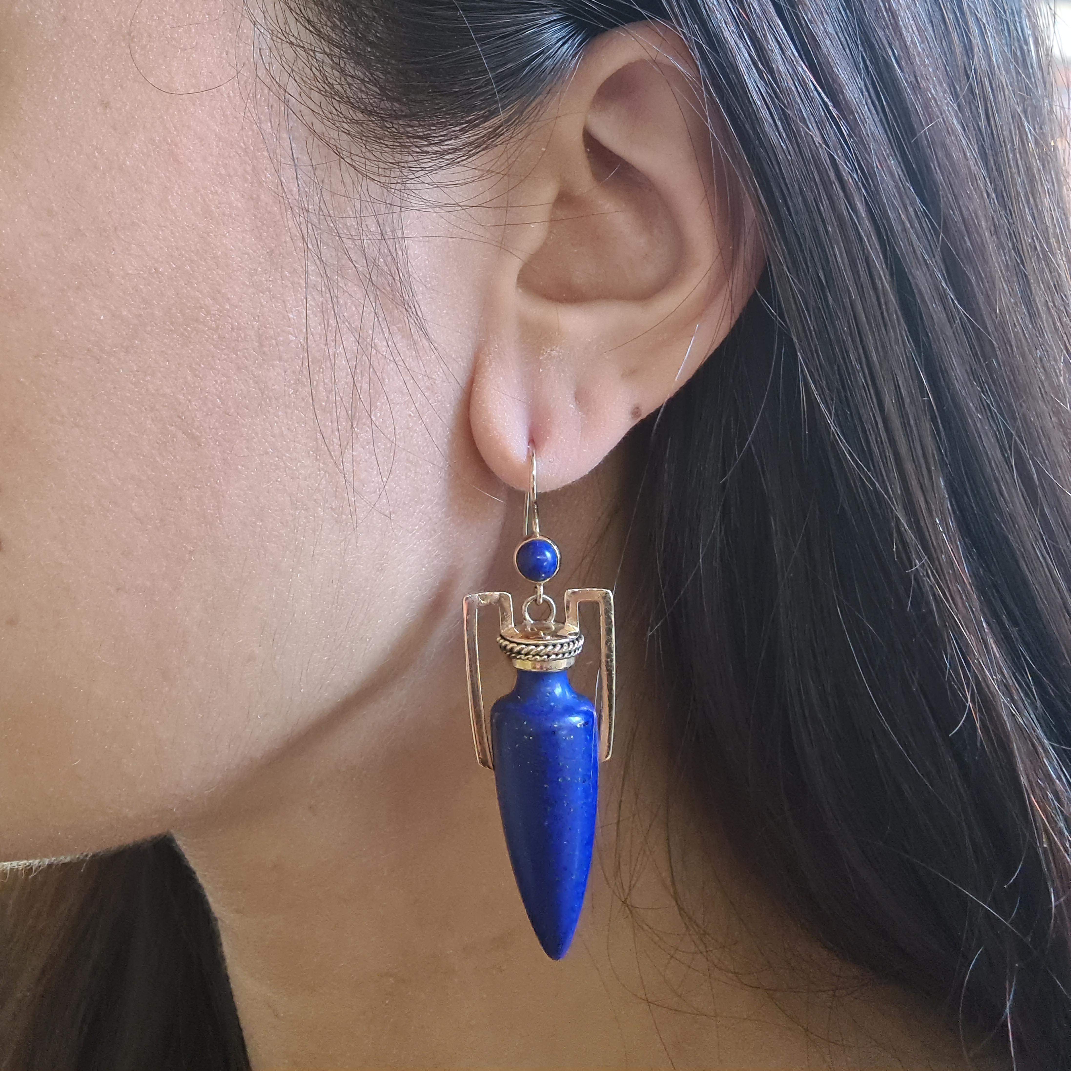 A pair of antique lapis lazuli and gold amphora earrings, with lapis lazuli forming the amphora vase and top, with gold handles and lids, with wire twist Etruscan style decoration, on ear wires, mounted in 14ct gold circa 1875. The earrings are