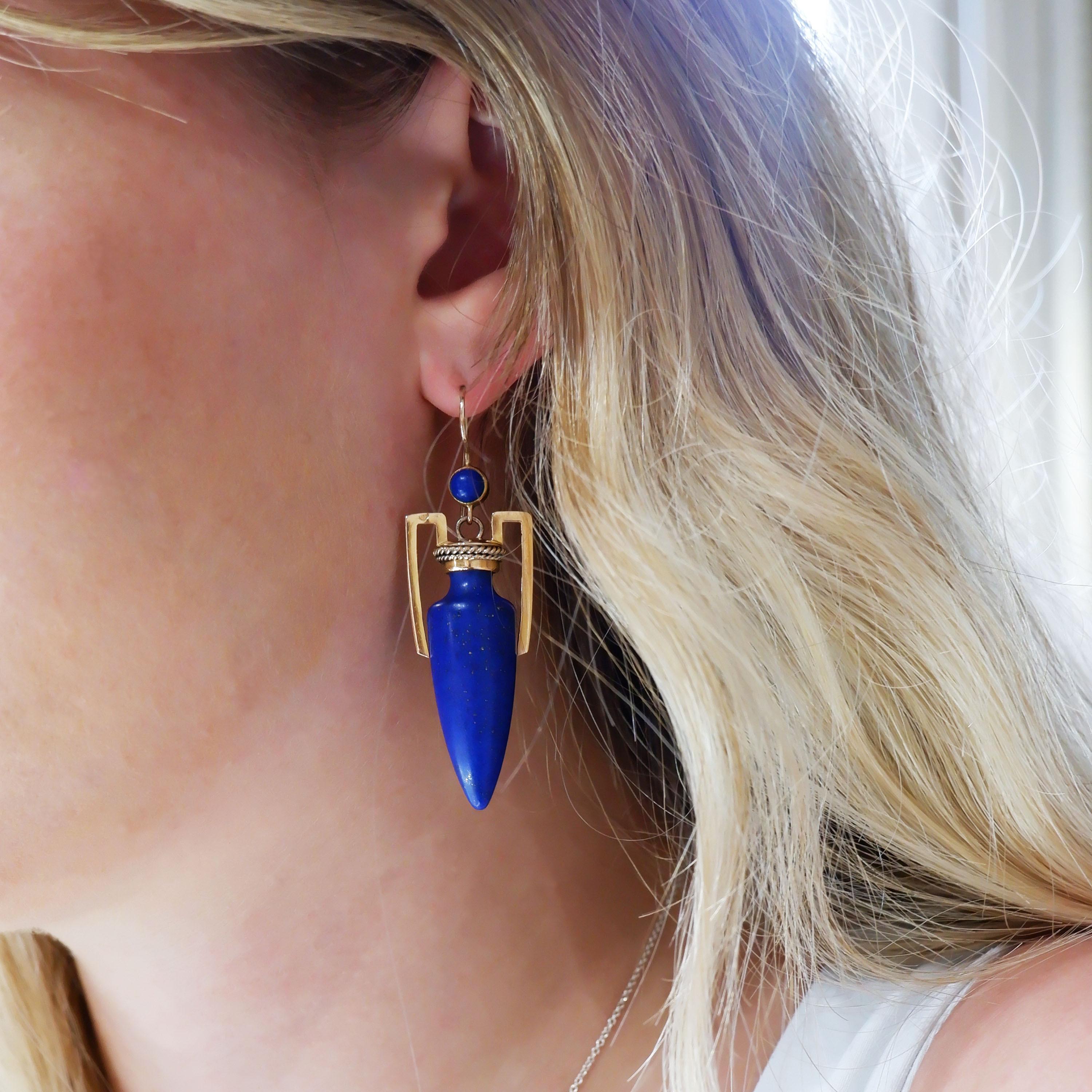 A pair of antique lapis lazuli and gold amphora earrings, with lapis lazuli forming the amphora vase and top, with gold handles and lids, with wire twist Etruscan style decoration, on ear wires, mounted in 14ct gold circa 1875. The earrings are