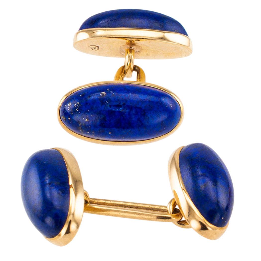 Antique lapis lazuli gold cufflinks circa 1900. The matching, double sided designs feature oblong lapis lazuli cabochons mounted in 14-karat yellow gold. We love the understated, classical and masculine elegance of these lapis lazuli cufflinks. The