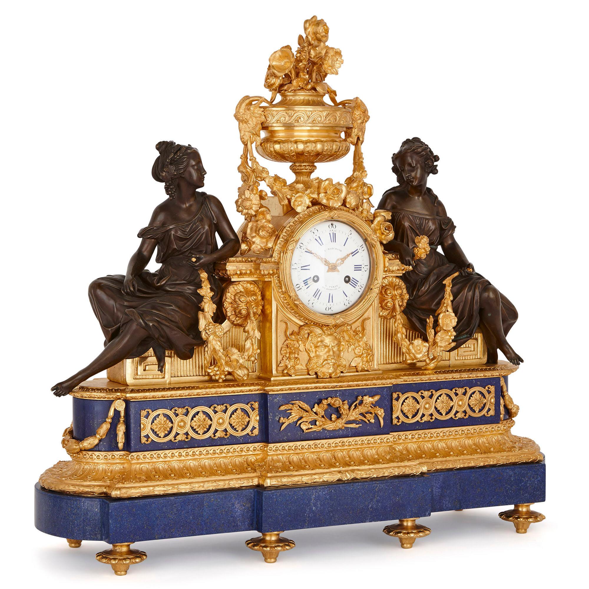 This beautiful mantlepiece set—which includes a clock and a pair of candelabra—was created in France in the late 19th century, circa 1870. The set is designed in an elegant Louis XVI (Neoclassical) style, and is crafted from gilt bronze (ormolu) and