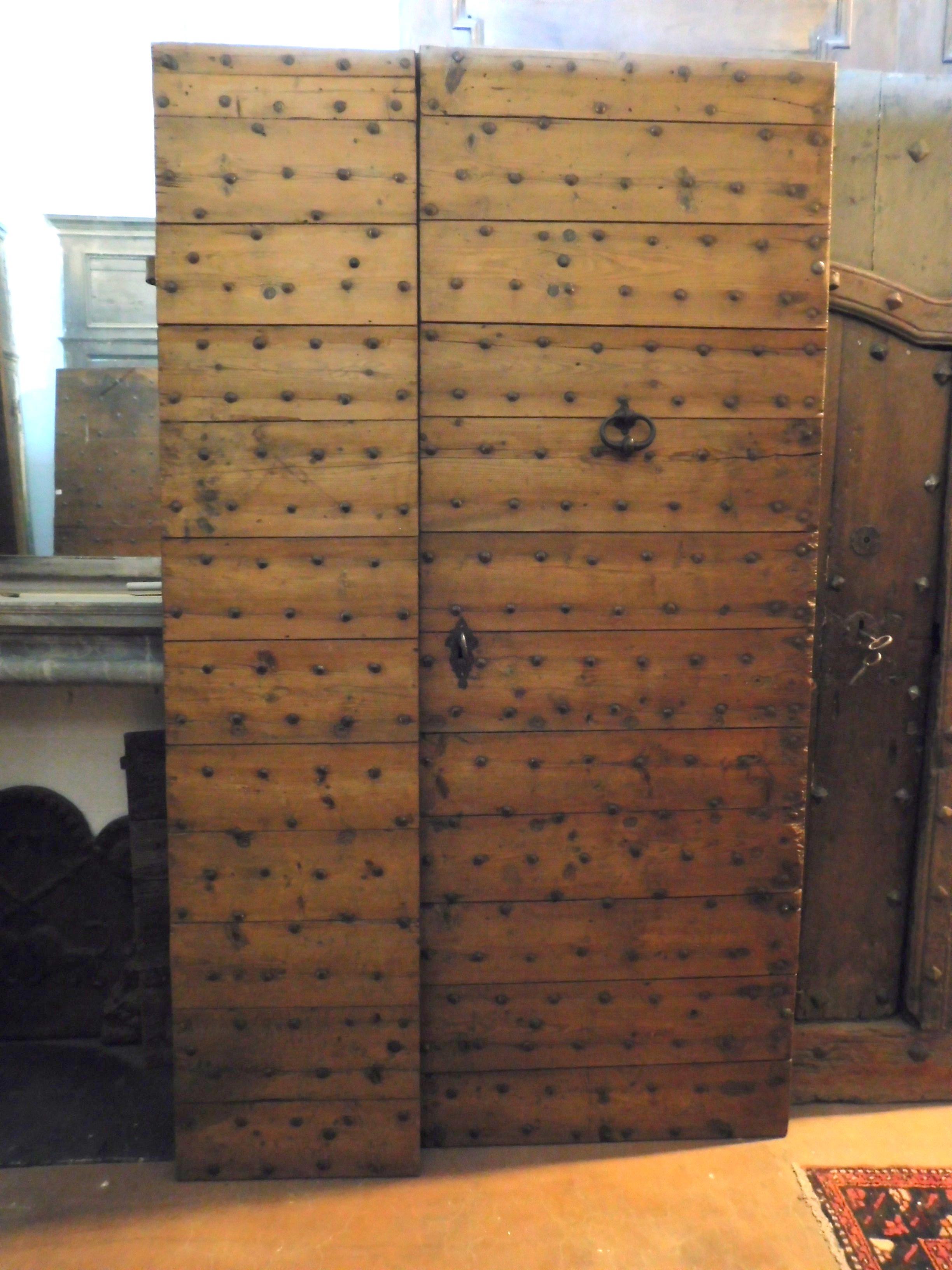 Antique entrance door in larch wood, with nails, rustic flavor, handmade in the 1700 in Italy, this particular entrance door has original needles and handles, nice thickened, usually opened 2/3 of the right and yes opened the remaining 1/3 when