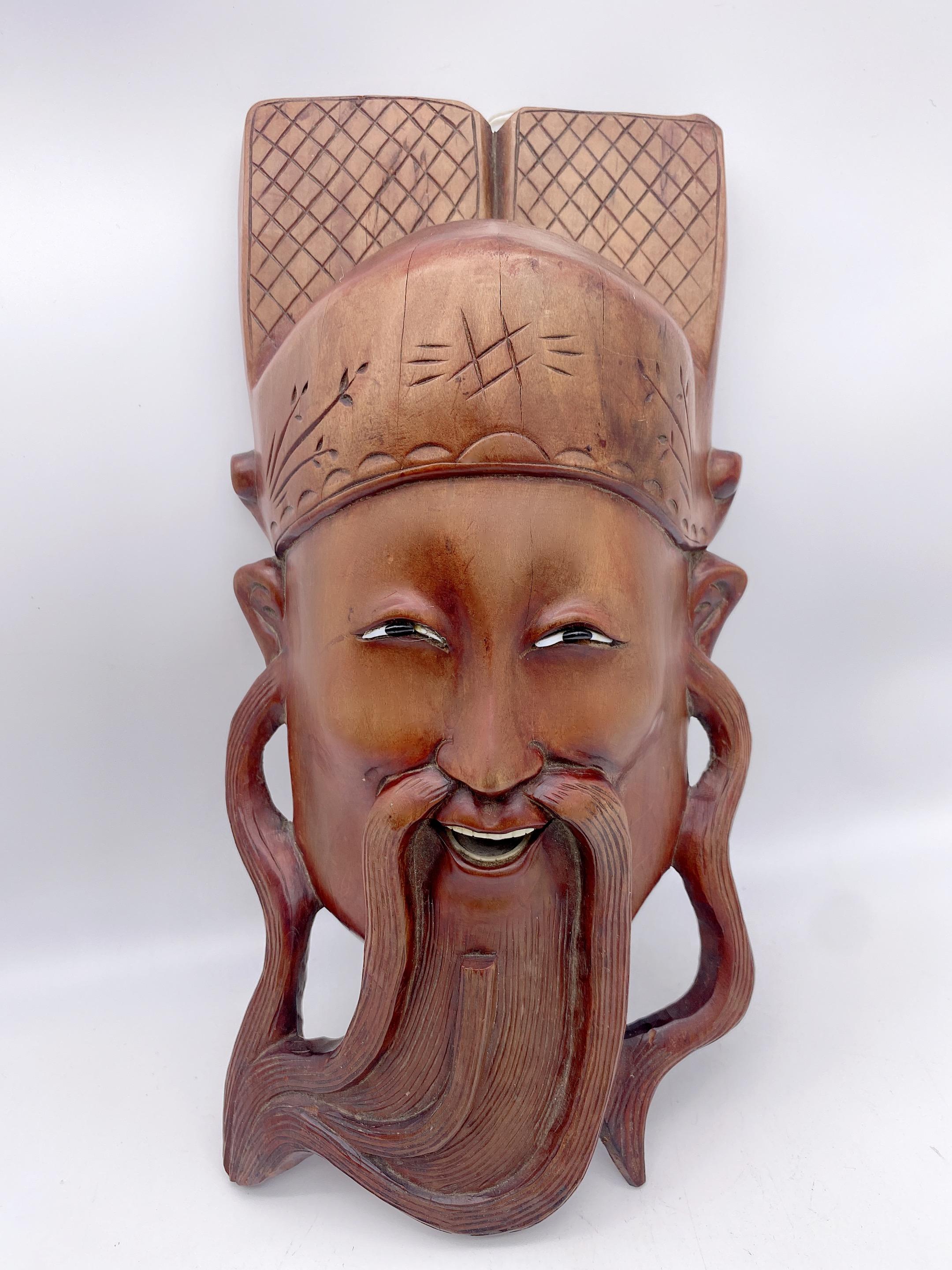 A antique Chinese heavily carved hardwood hanging woodcarving , looks very beautiful smiling face with teeth and hat, see more pictures, measures: 12'' X 5.5'' X 3.5''.
