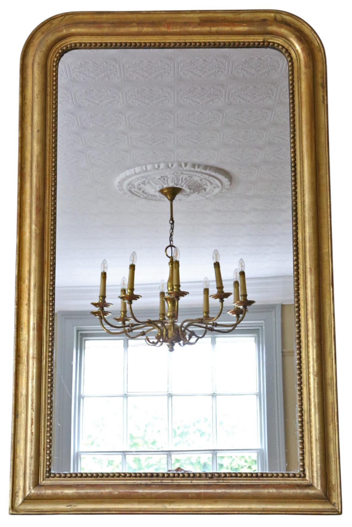 Antique Large 19ème siècle Gilt Overmantle Wall Mirror - High-Quality

Cet élégant miroir à trumeau doré du XIXe siècle présente un design à la fois saisissant et simple, ce qui en fait un ajout captivant à tout espace approprié. Le cadre solide n'a