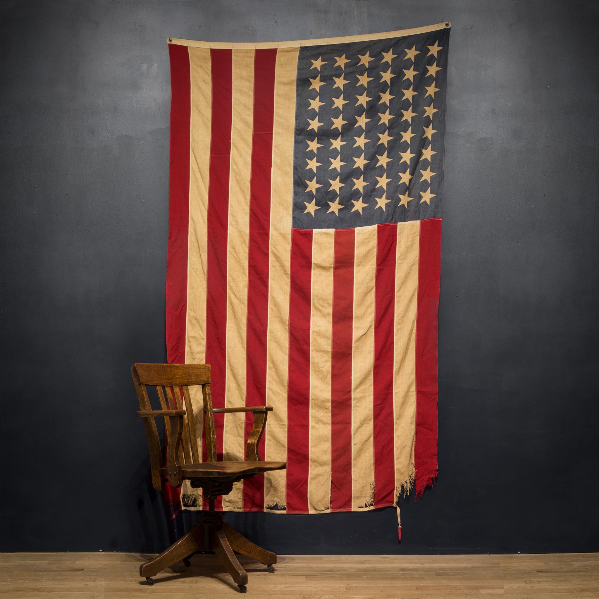 This is an original fabric large American flag with 48 stars. The flag has retained its original color with some structural damage slight fading.

Creator Unknown.
 Date of manufacture circa pre 1940s
Materials and techniques: Fabric.
Condition: