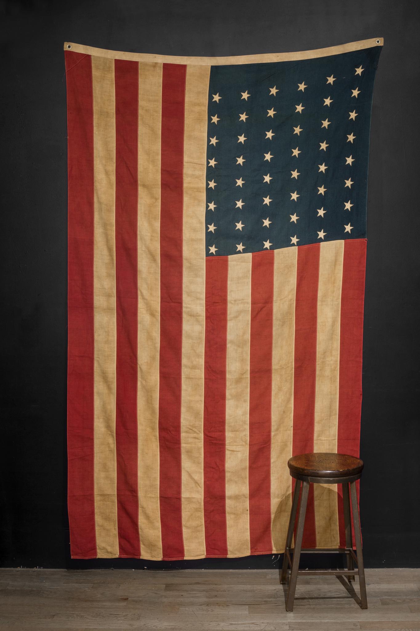 This is an original fabric large American flag with 48 stars. The flag has retained its original color with some slight fading.

Creator Unknown.
 Date of manufacture circa pre 1940s
Materials and techniques: Fabric.
Condition: Good. Wear