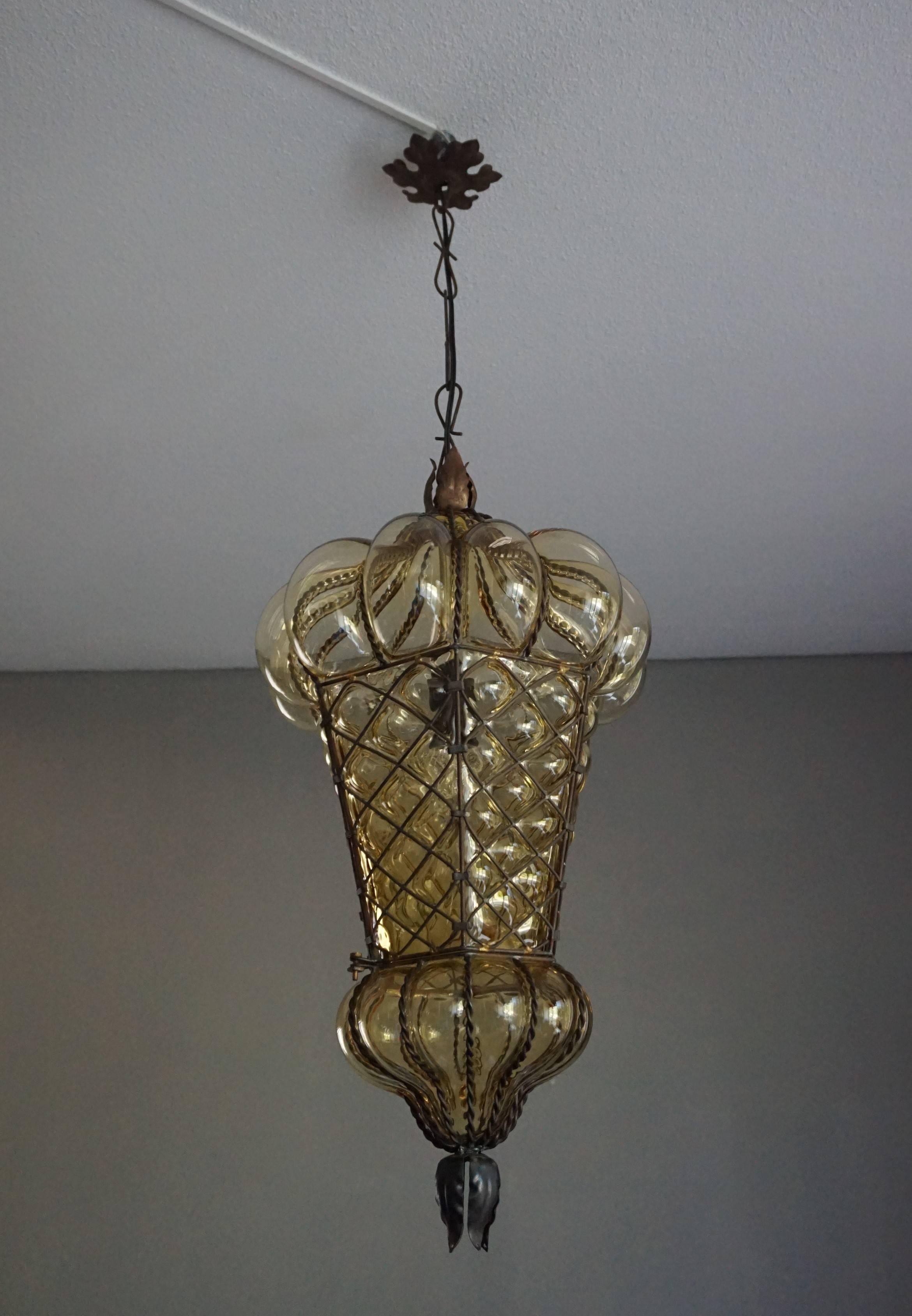 Large, amber colored and great condition Venetian light fixture.

This antique Venetian pendant is not only the largest of it's kind we ever had the pleasure of offering, it also is in exceptional condition. We have completely rewired it for safe