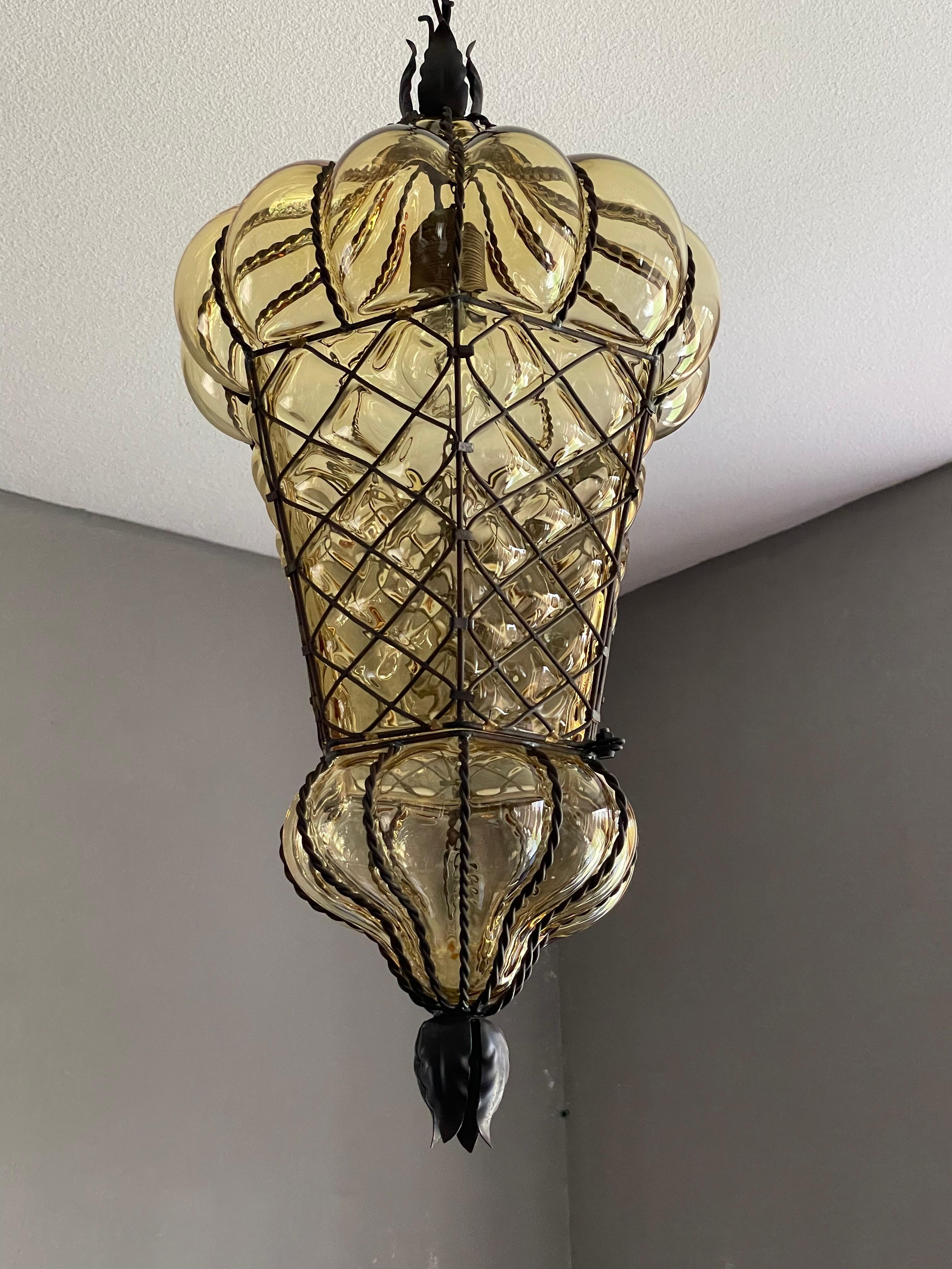 Large, amber colored and great condition Venetian Murano light fixture.

This antique Venetian pendant is not only one of the largest of its kind that we ever had the pleasure of offering, it also is in exceptional condition. We have completely