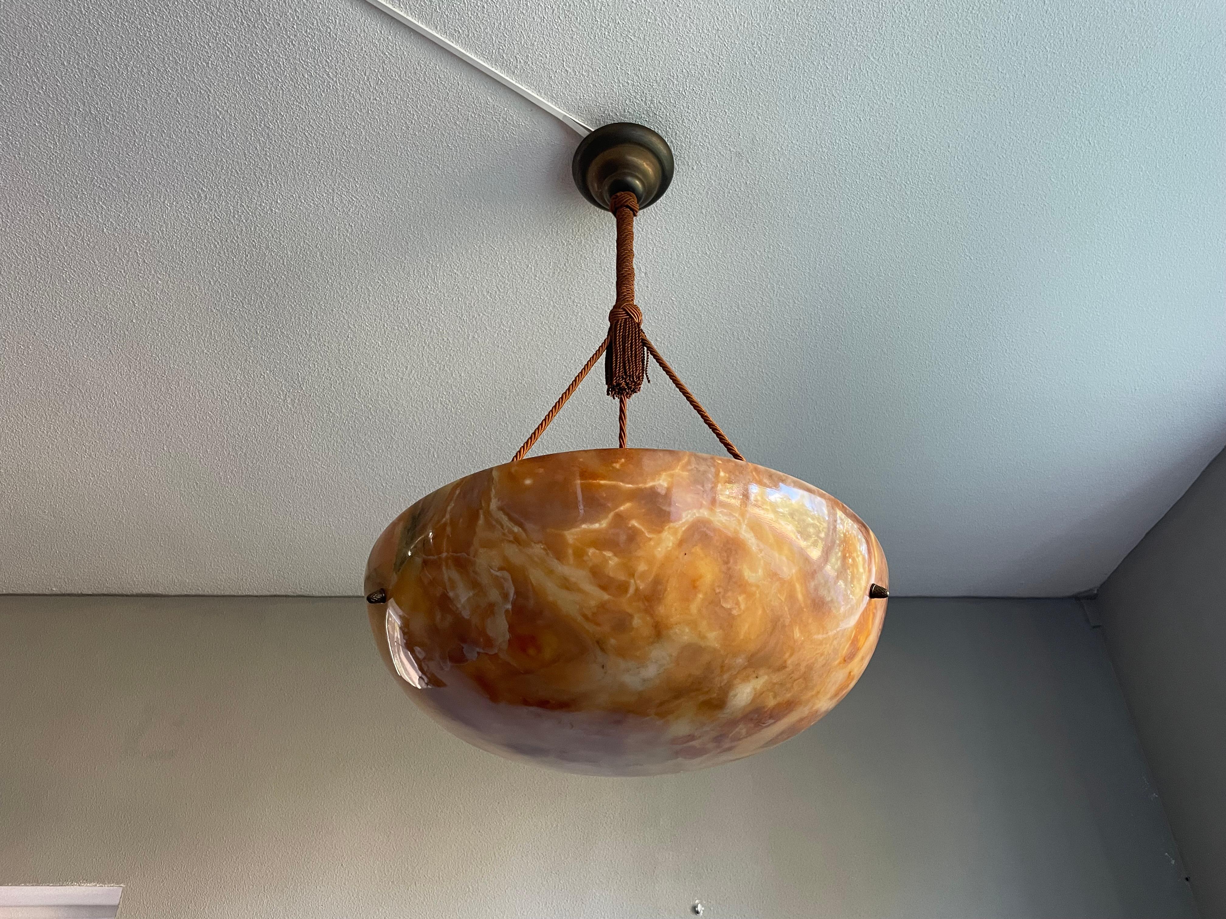 One of a kind light fixture with a stunning “ flameboyant “ alabaster shade.

Thanks to its timeless design, its large size and its truly excellent condition this three light alabaster chandelier will light up both your days and evenings, both in