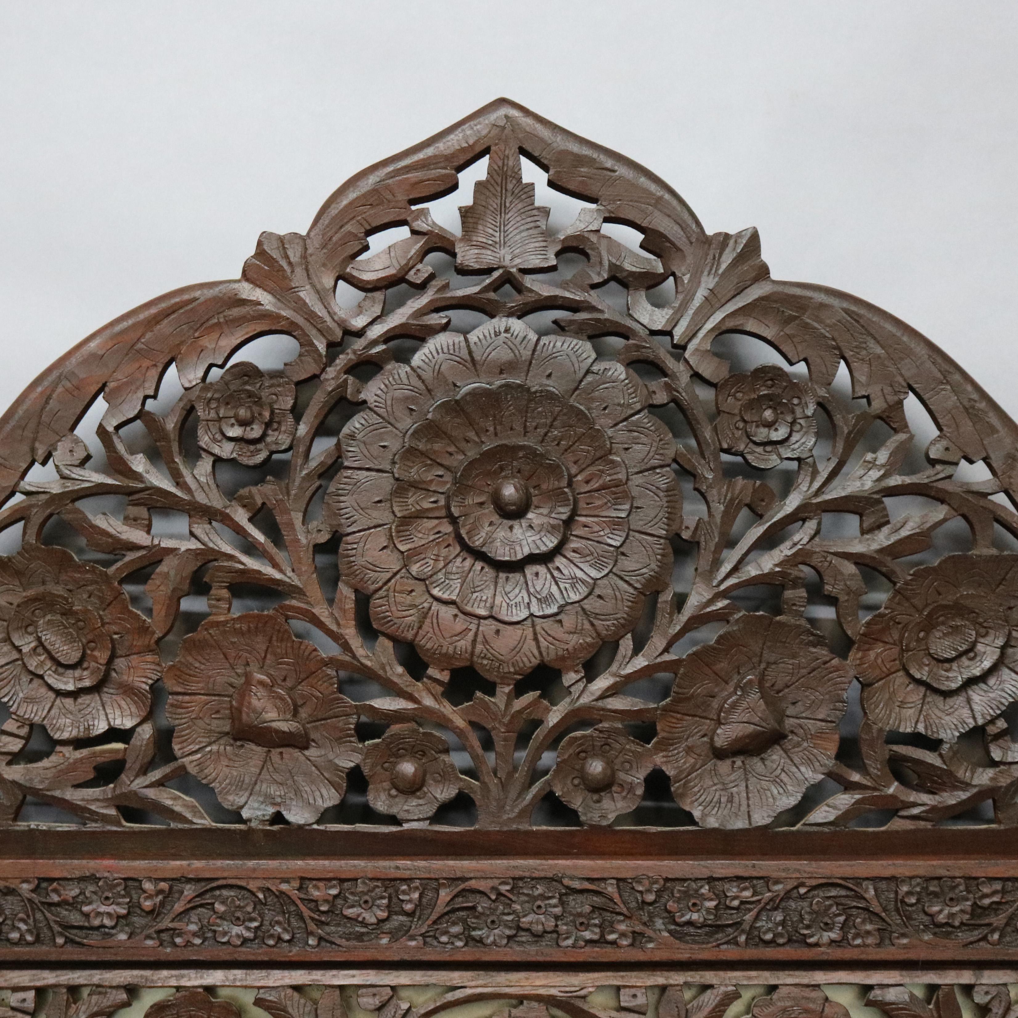 An antique and large Anglo-Indian wall mirror offers reticulated frame with carved floral design and arched crest, c1930

Measures: 55