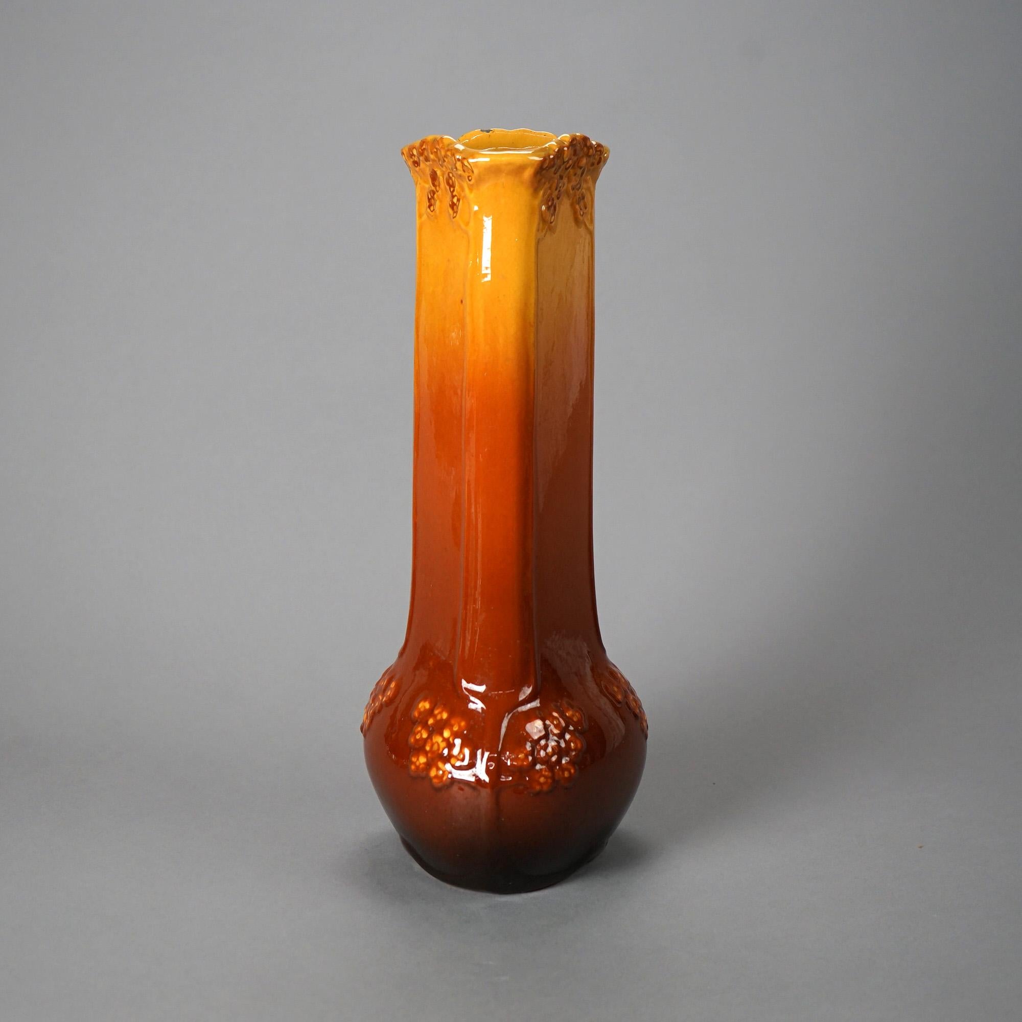 A large antique Art Nouveau vase by Weller offers art pottery construction in stylized triangulated bottle form and having foliate elements in relief, maker marked on base as photographed, c1920

Measures - 15.5
