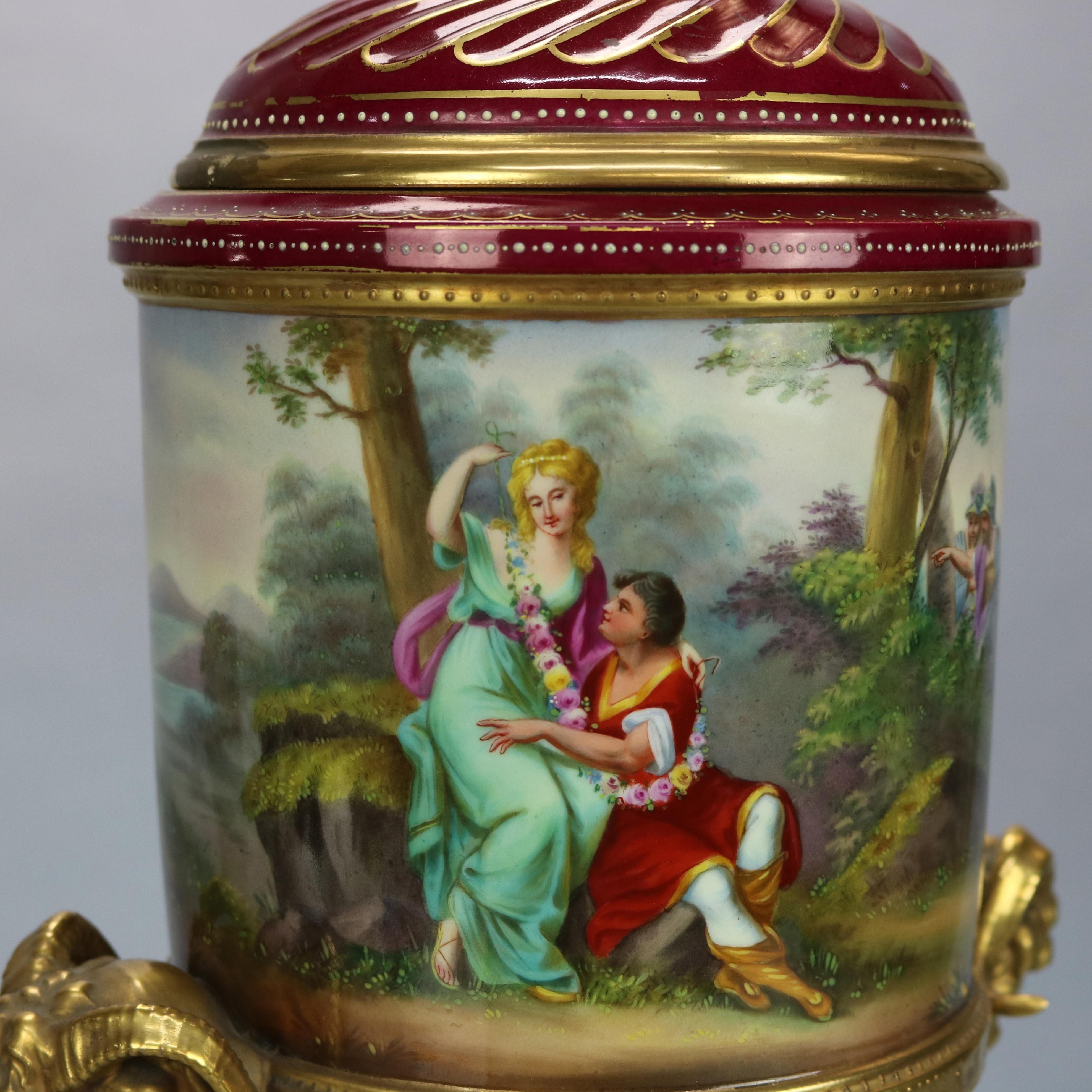 An antique and large Neoclassical artist signed urn by Royal Vienna offers porcelain construction with swirl lid having gilt pineapple finial and surmounting scenic urn having hand painted courting scene and en verso three Muses with cherub in