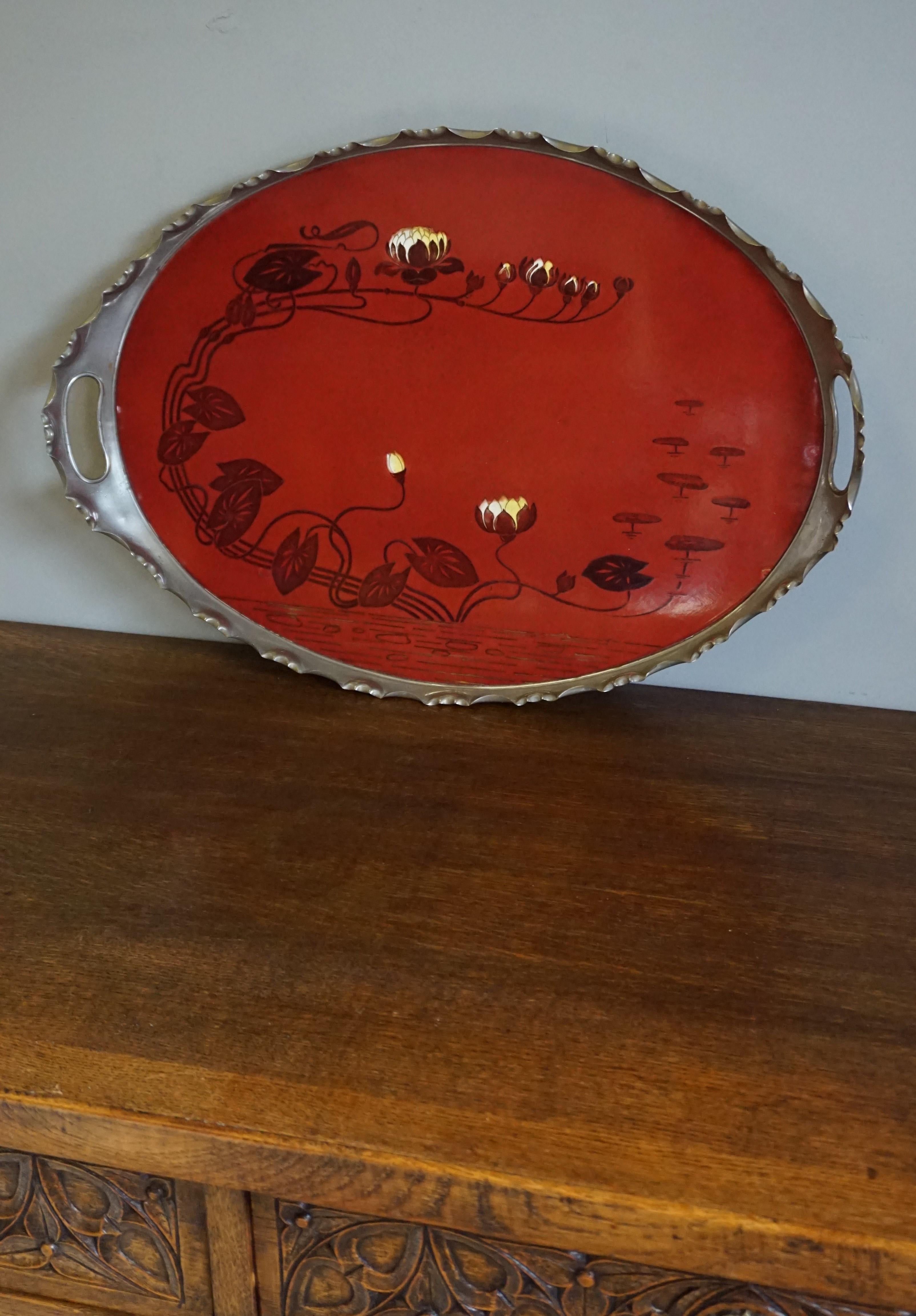 Rare and beautifully hand painted porcelain tile in chrome metal frame serving tray.

This beautiful quality, oval shaped tile serving tray is an absolute joy to own and to look at. It is one of the largest, single tile serving trays we have ever