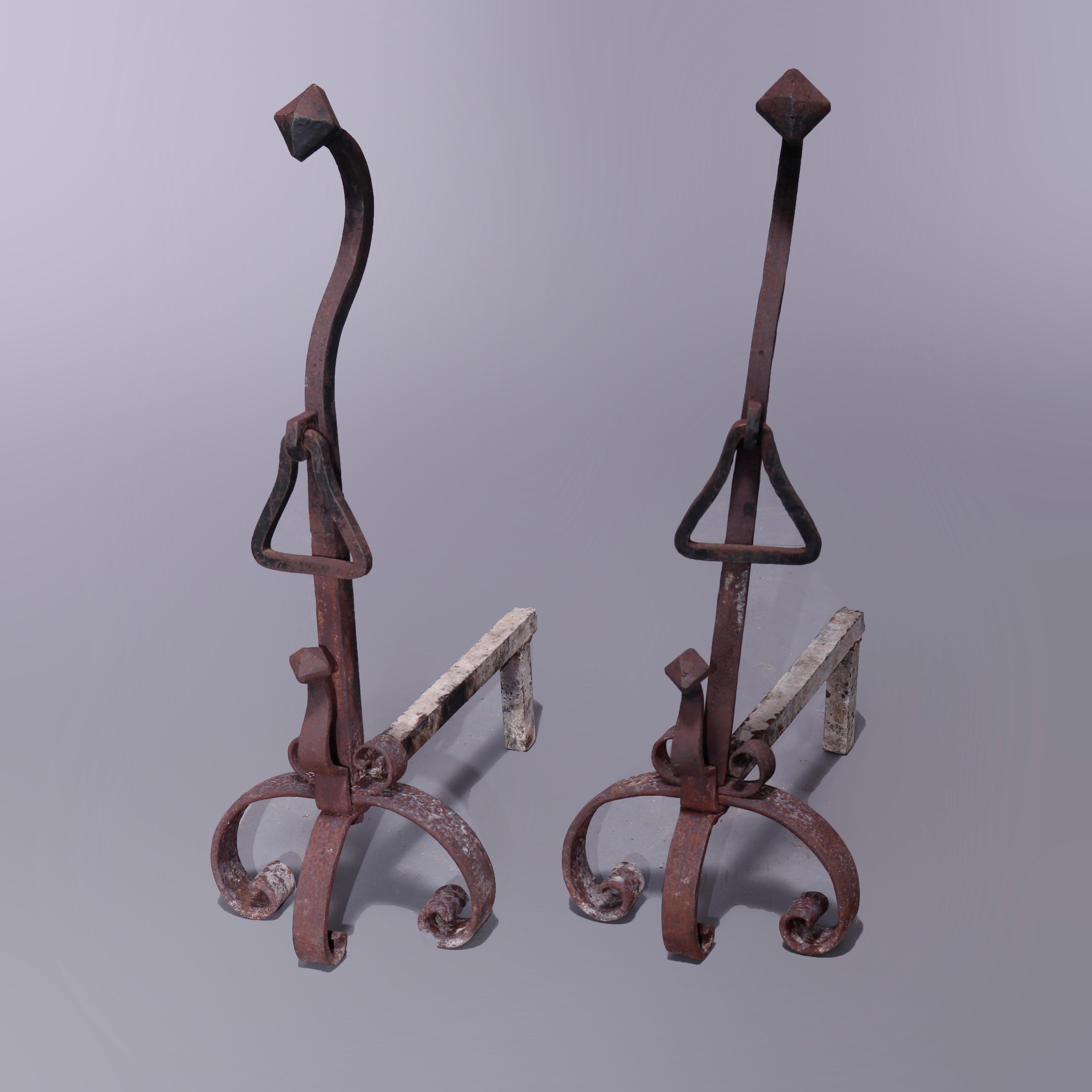 An antique pair of oversized Arts and Crafts andirons in the manner of Yellin offer wrought iron construction with pyramidal finials over shaped shaft and raised on scroll form feet, c1900

Measures - 30.5'' H x 10.5'' W x 20'' D.

Catalogue Note: