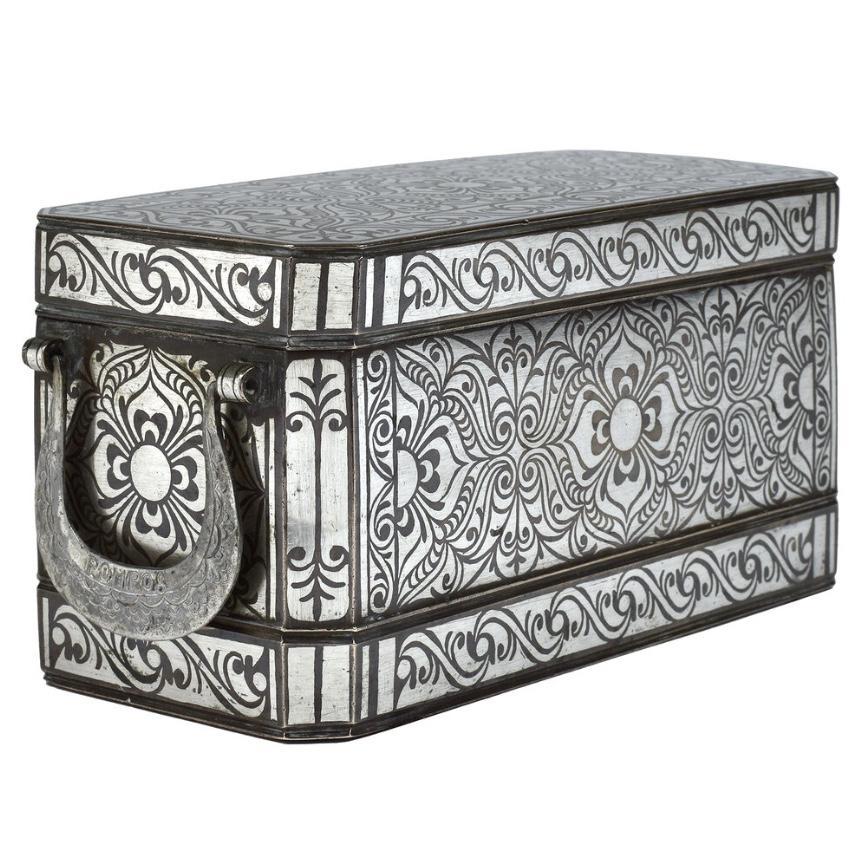 Large Betel Nut Box, Maranao, Southern Philippines (Mindanao).
Bronze with bordered silver inlay design overall of a symmetrical floral tendril vine pattern referred to as “the okir pattern”,  a traditional design for the Maranao people. This large