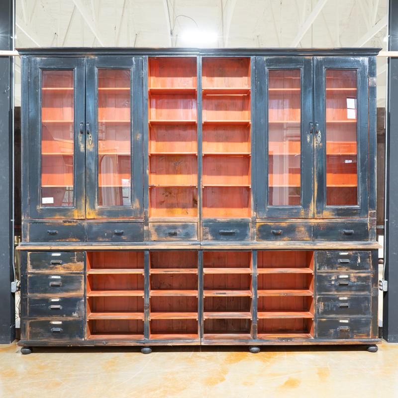 At 11' wide and over 9' tall, this amazing old apothecary will make an impressive wall unit or display cabinet. The variety of glass doors, open shelving, and lower drawers are all well balanced visually, allowing for creativity in your display.
