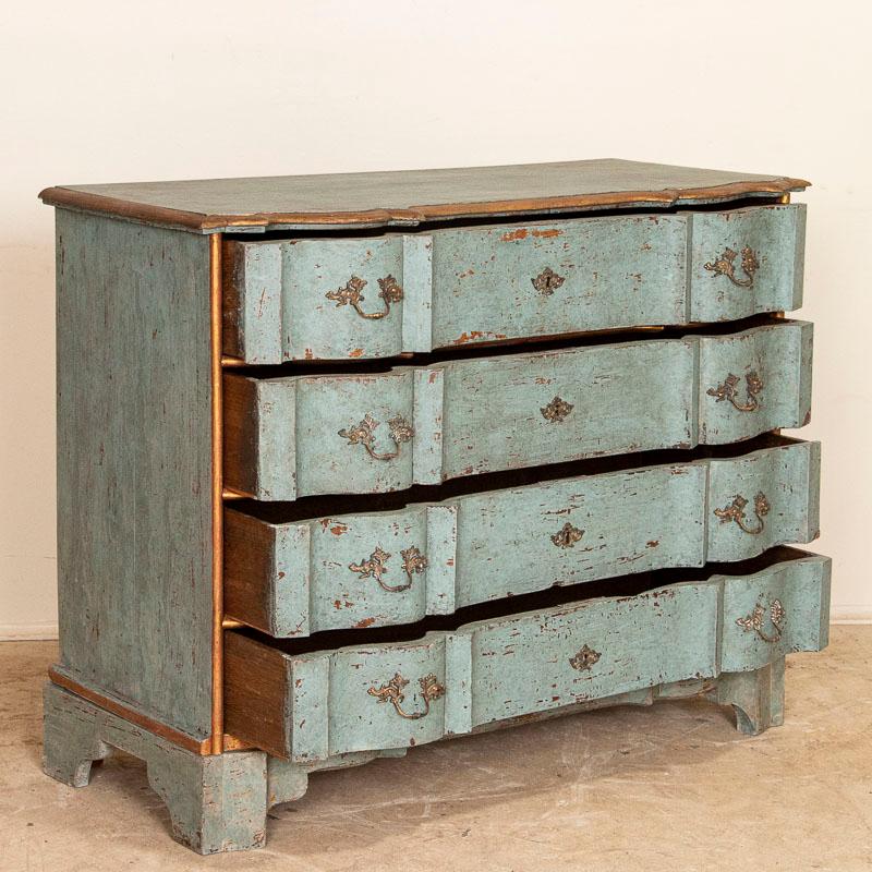 The blue painted finish is captivating on this large oak chest of four drawers. Enlarge the photos to appreciate the balance of blue paint and gold trim (with red undertones) which are all perfectly distressed to reveal the natural oak below. The