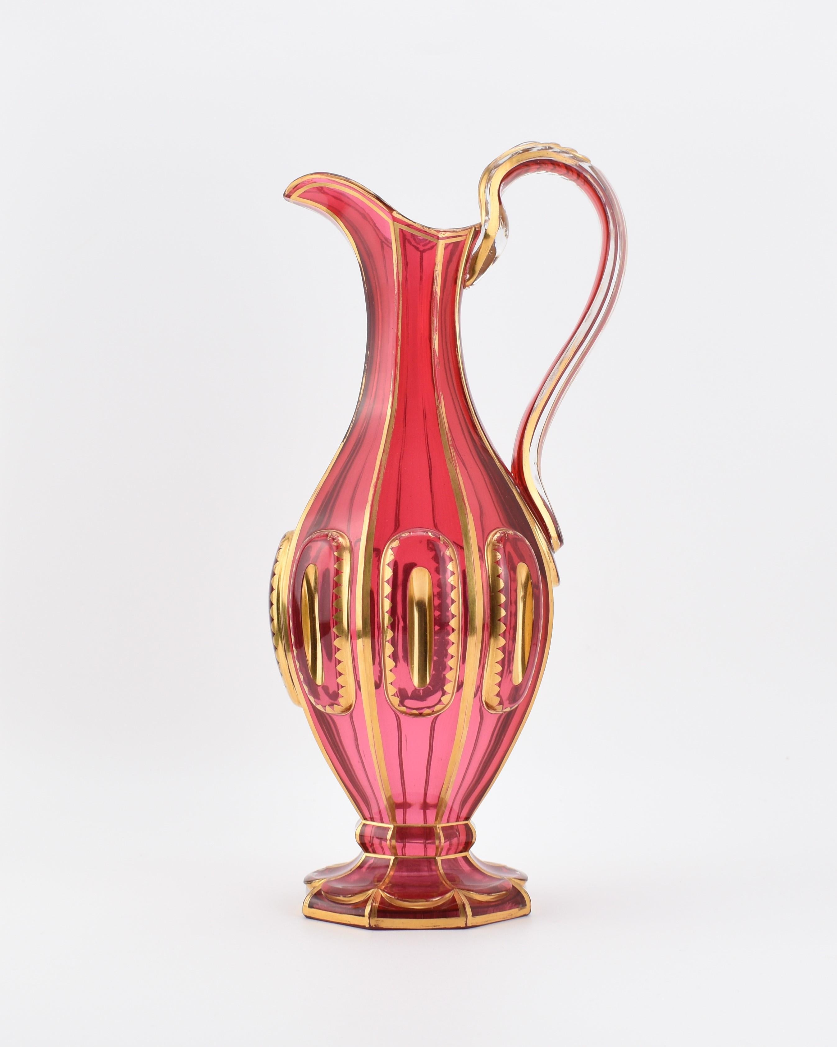 Large Antique Cranberry Glass Pitcher – Bohemia, 19th Century

This impressive antique cranberry glass pitcher, crafted in Bohemia during the 19th century, features a circular body expertly cut into 8 panels, separated by vertical lines of gold.