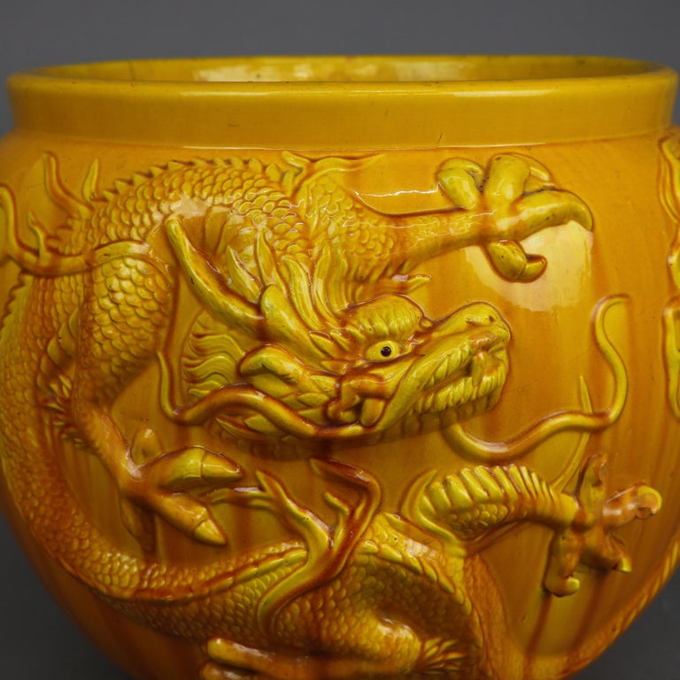 An antique and oversized English jardiniere by Bretby offers pottery construction with Japanese dragon in relief, maker mark on base as photographed, c1900

Measures - 15''H x 17.5''W x 17.5''D.

Catalogue Note: Ask about DISCOUNTED DELIVERY RATES
