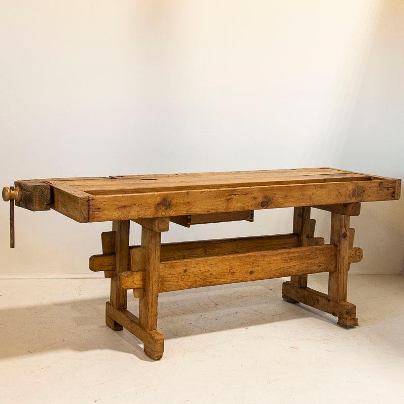 The wood and depth patina on this particular work table comes from years of constant use. It has one wooden vice and a recessed tray where the carpenter would lay his tools (notice the wonderful grain in the wood). Unique to this workbench is the