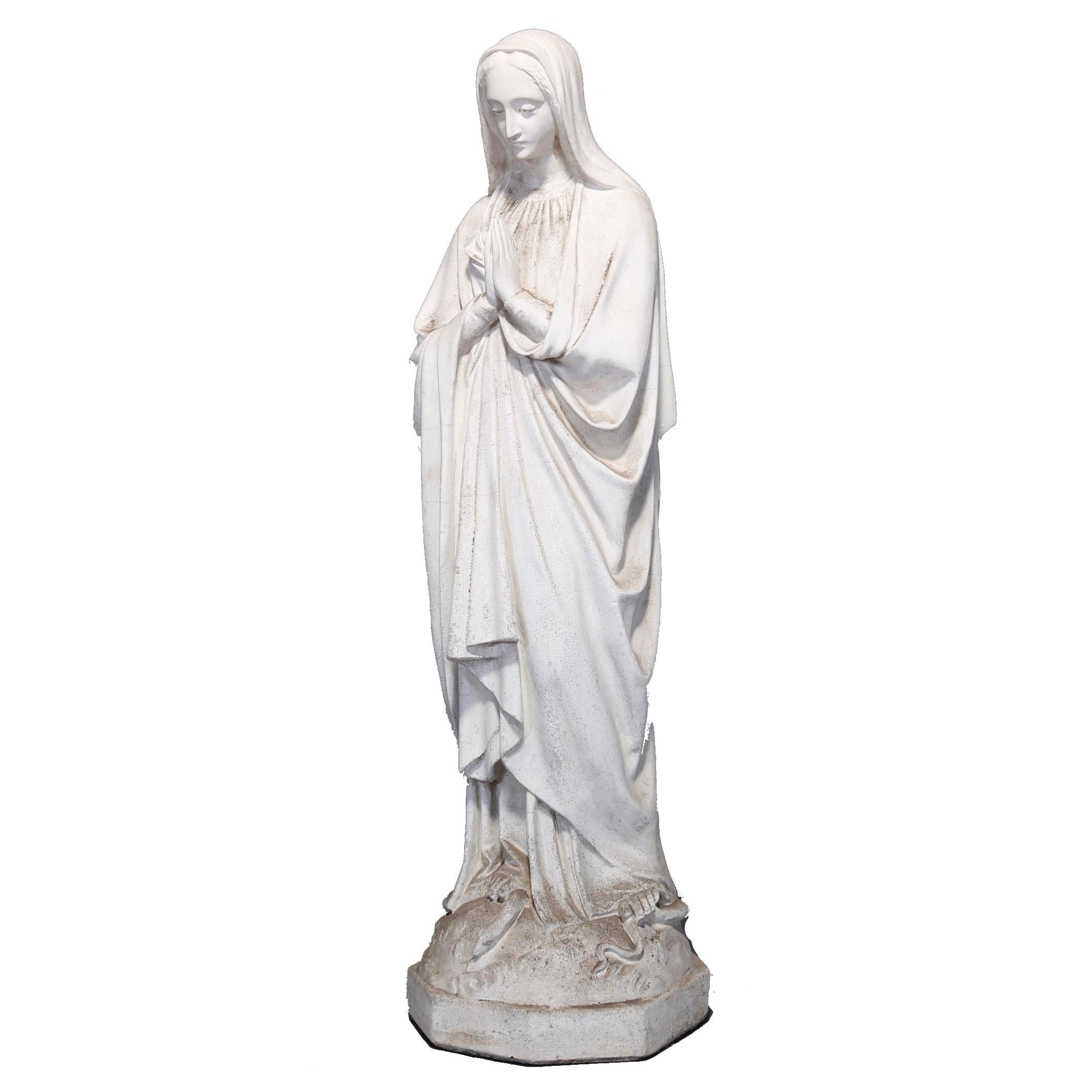 An antique and large cast hard stone sculpture depicts praying Mother Mary with serpent underfoot on octagonal plinth, circa 1910.

Measures: 50