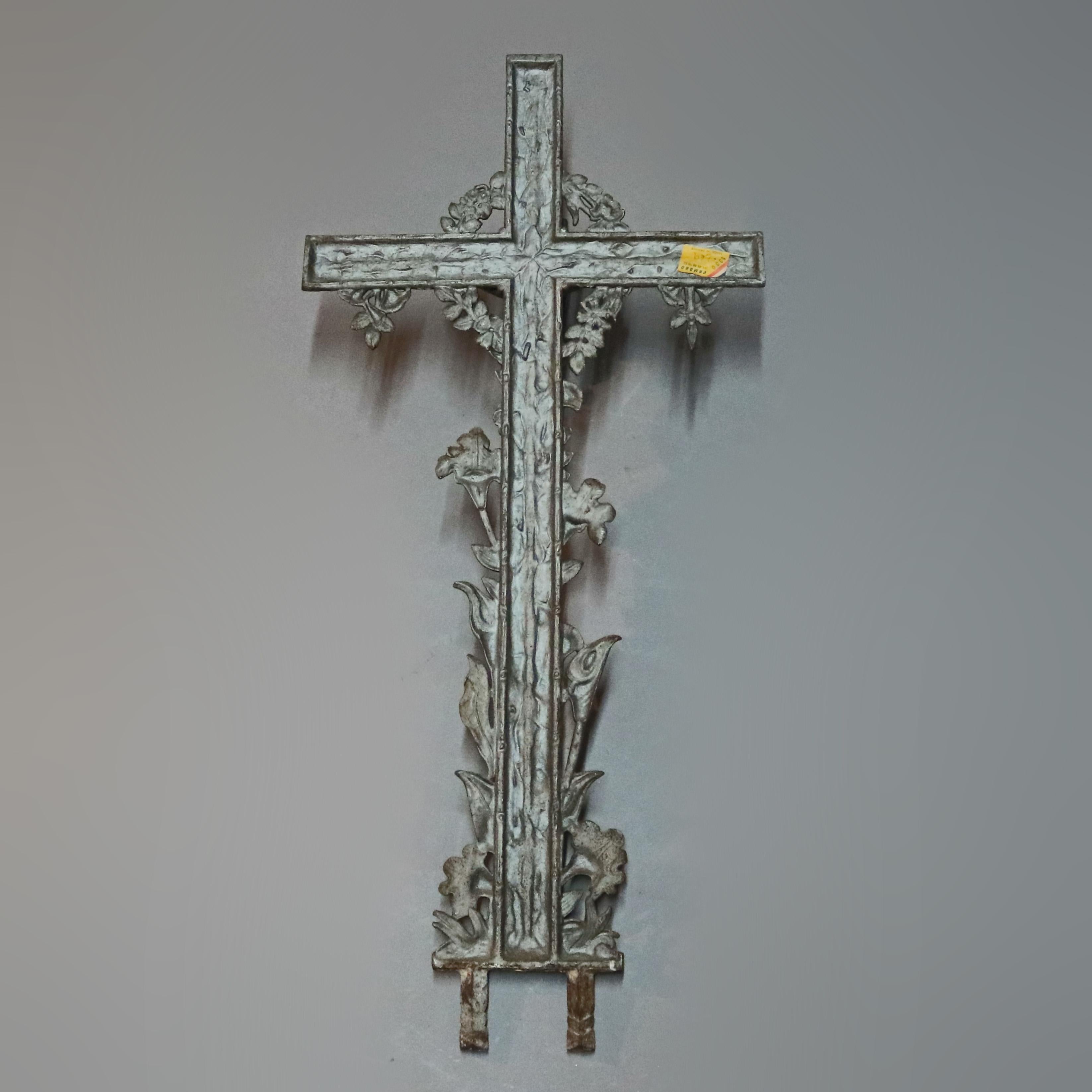 An antique and large cast iron crucifix offers cross with Jesus Christ with floral and foliate elements in high relief, base with double stakes, circa 1900

Measures: 42.25