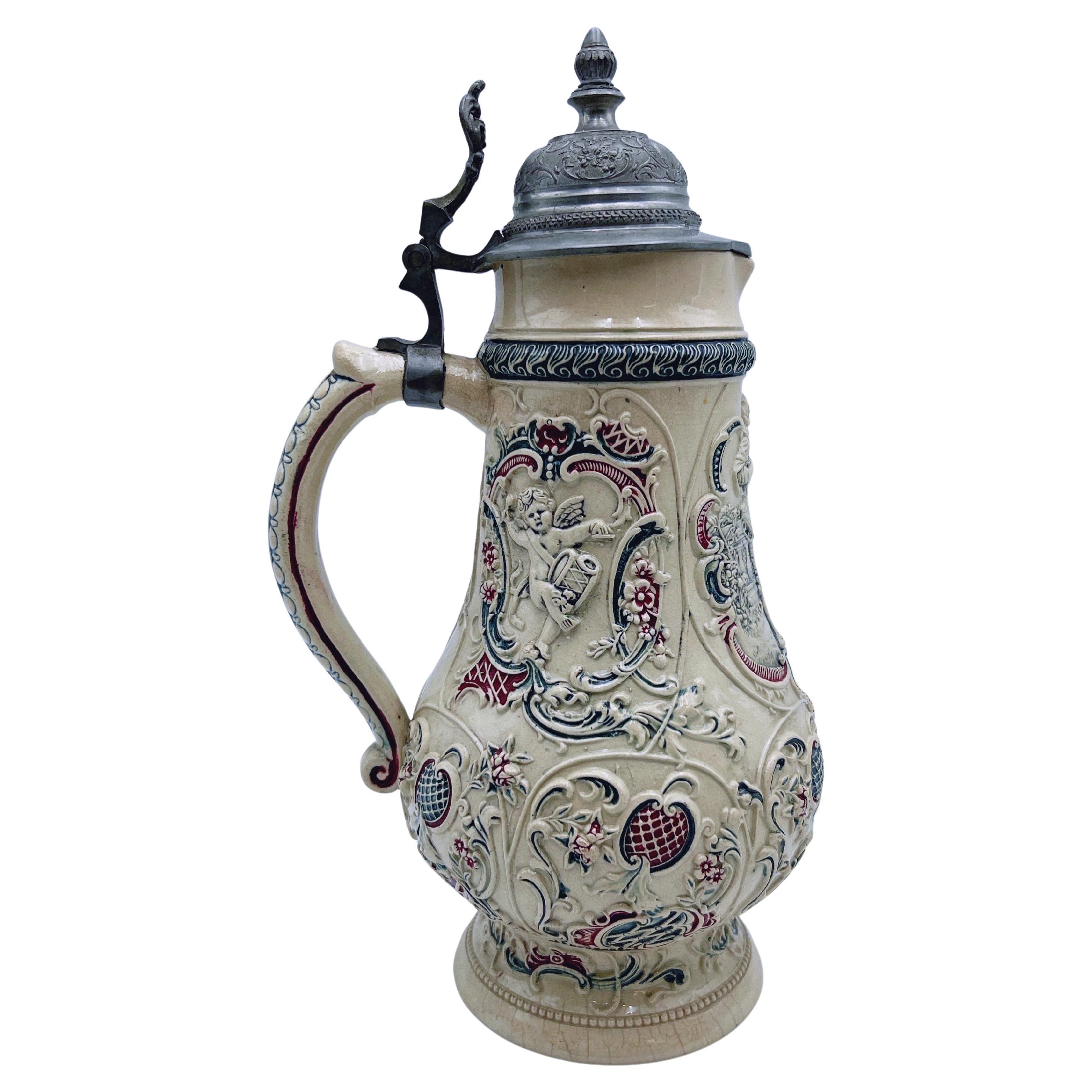 Stunning One-of-a-Kind Large Tankard in Ceramic/Stoneware with Richly Decorated Relief Motif of Wedding Couple and Angels

Ivory base color, partly painted in green and red, with an original pewter lid. Marked 
