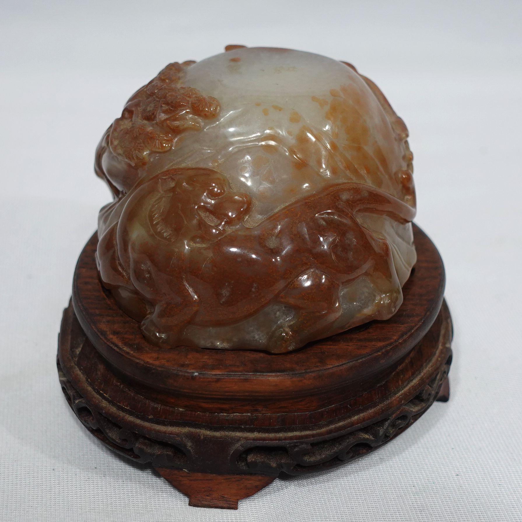 A fine and beautiful Carved Agate Animal Group depicts trees, a Tiger, and a Baffulor resting on a fitted wooden base. A large and heavy piece.
Dimension: 4.5