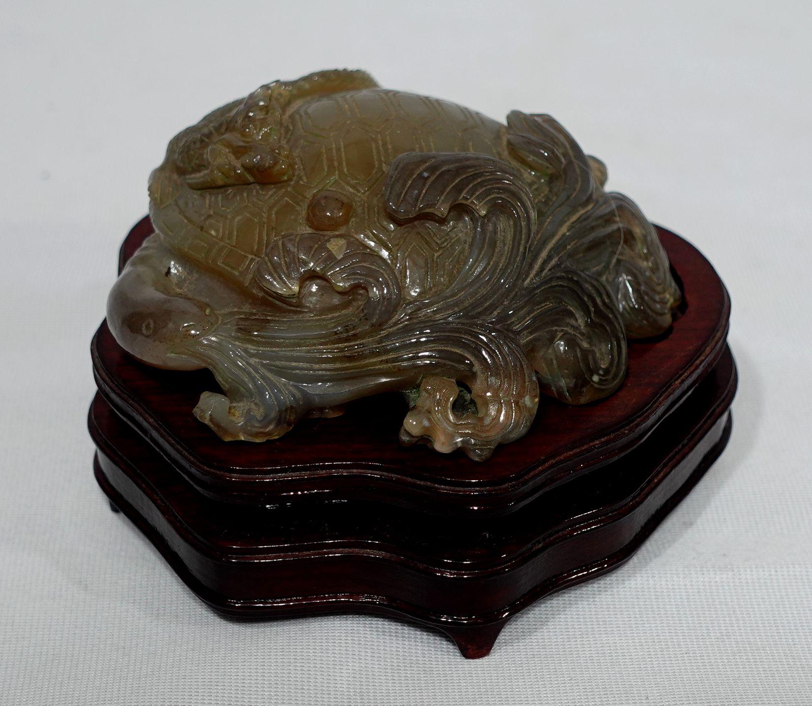 A fine and beautiful Carved Agate Animal Group depicts a turtle, dragon, and cloud with sea waves. rest on a fitted wooden base. A large and heavy piece.
Dimension: 4.5