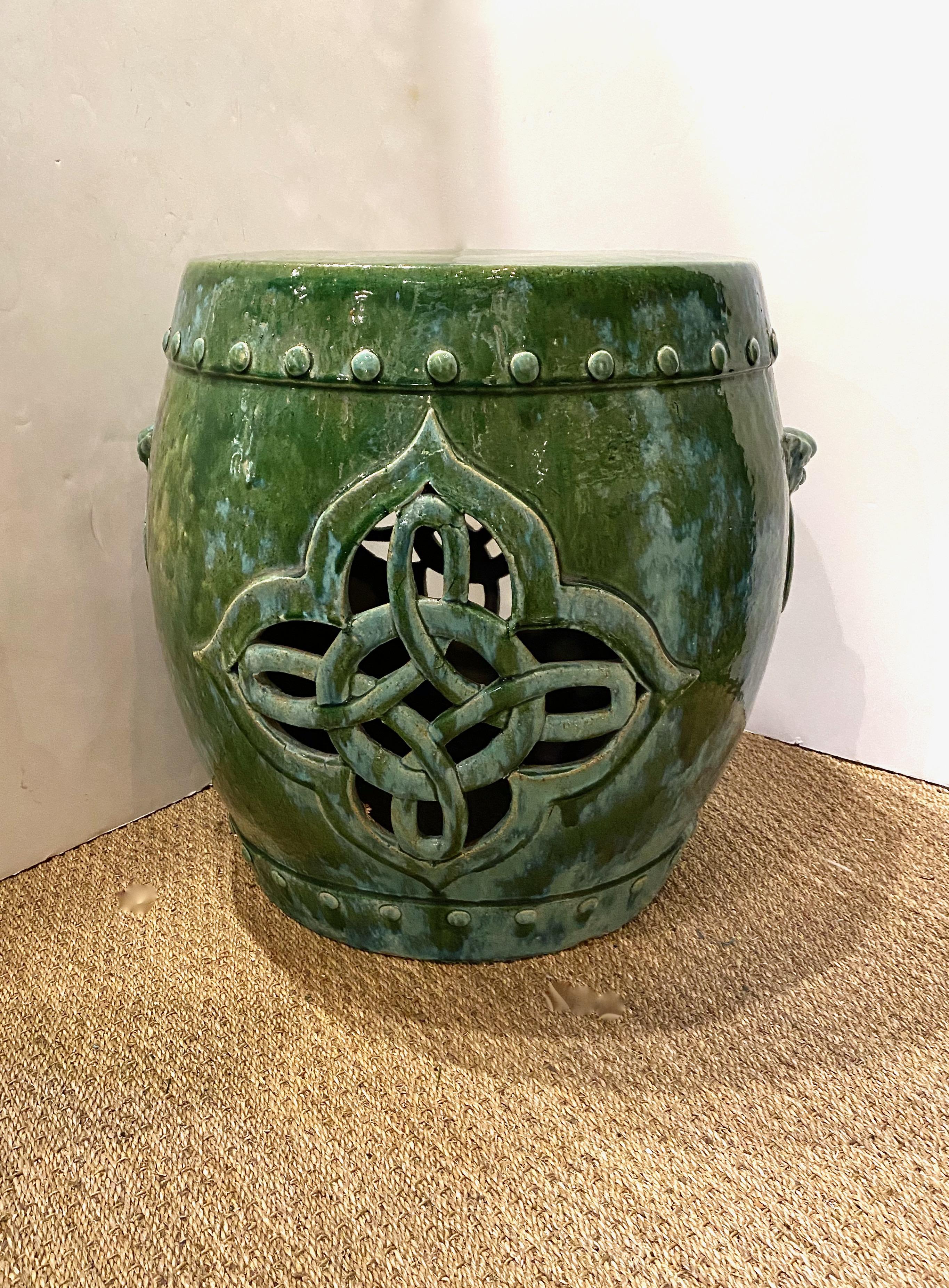 This a large glazed terra cotta table in the form of a traditional Chinese drum. The table dates to the late 19th or early 20th century and is in overall very good condition considering its many years of use. The traditional green is highlighted