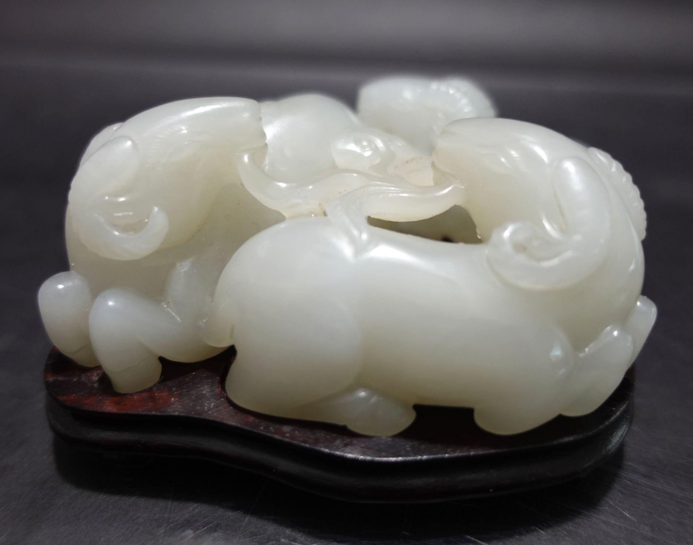A nice hand-carved antique, a Large and Heavy Chinese Hetain White- Light Gray Jade of 3 Rams resting on the fitted wooden stand., 360° carving. There is a meaning behind this artwork. Three Rams read 