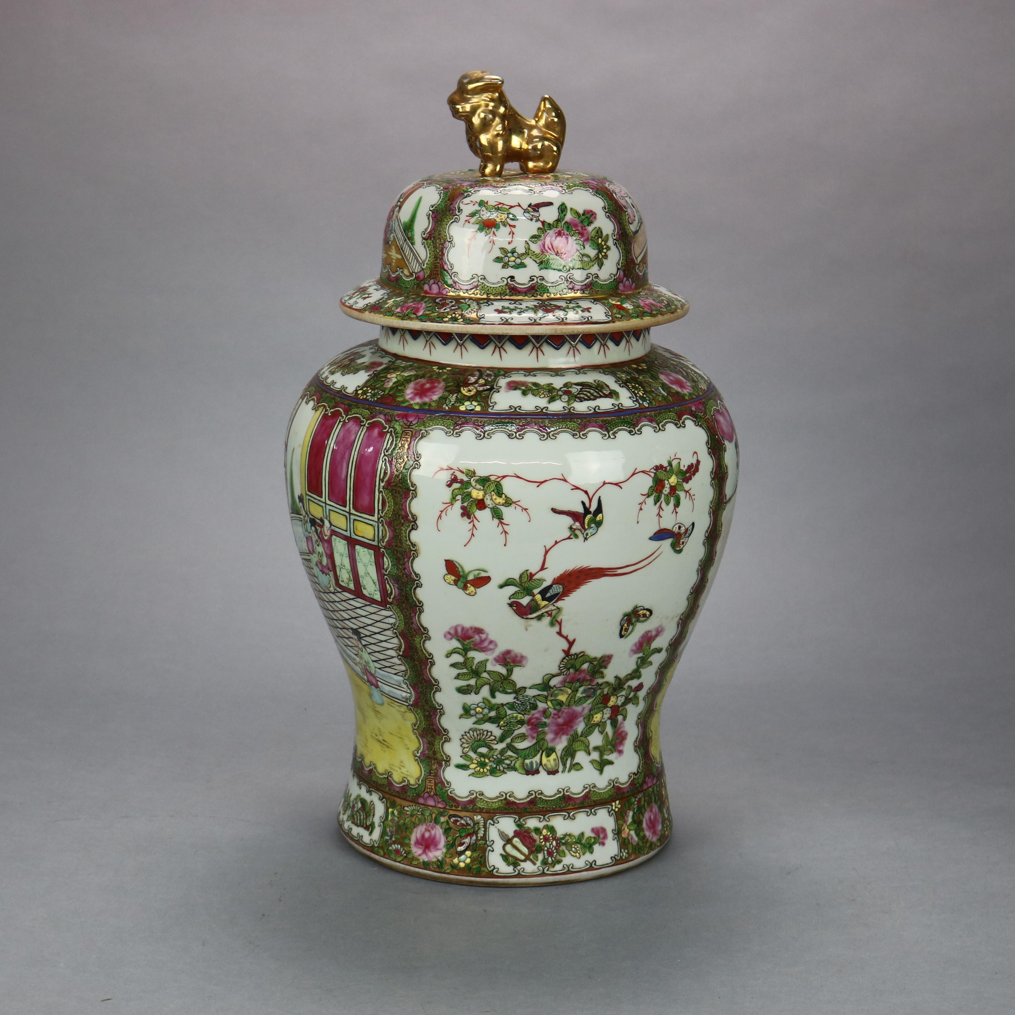 An antique pair of large Chinese ginger jars offer enamel decorated porcelain construction with genre and garden scenes and having lids with figural foo dog finials, gilt highlights throughout, stamped on bases as photographed, 20th