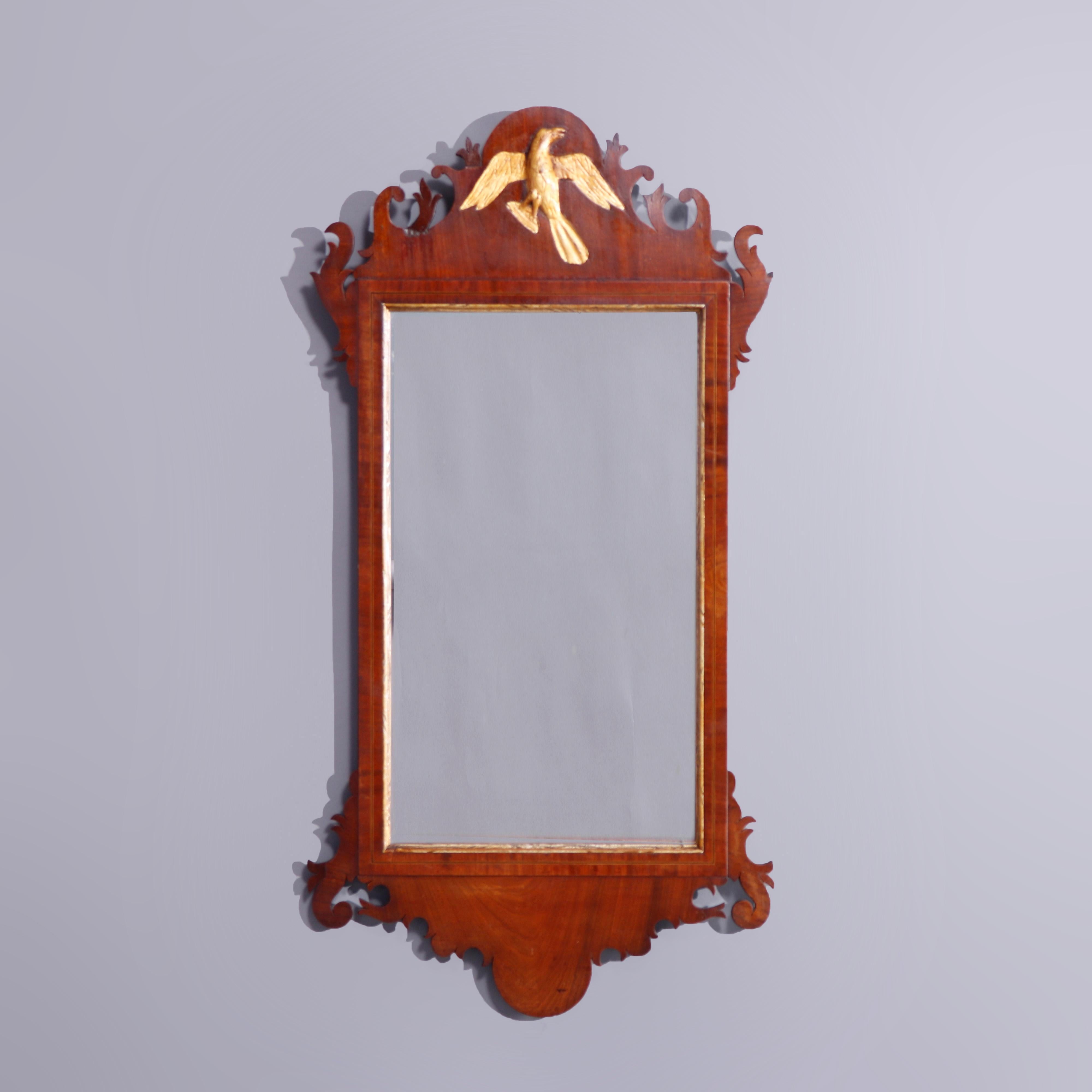 An antique and large Chippendale style mirror offers shaped parcel gilt mahogany frame with scroll and foliate border with gilt phoenix at crest, c1810

Measures - 40.25'' H x 20.5'' W x 1.25'' D; sight 14.25'' x 28.5''.

Catalogue Note: Ask about