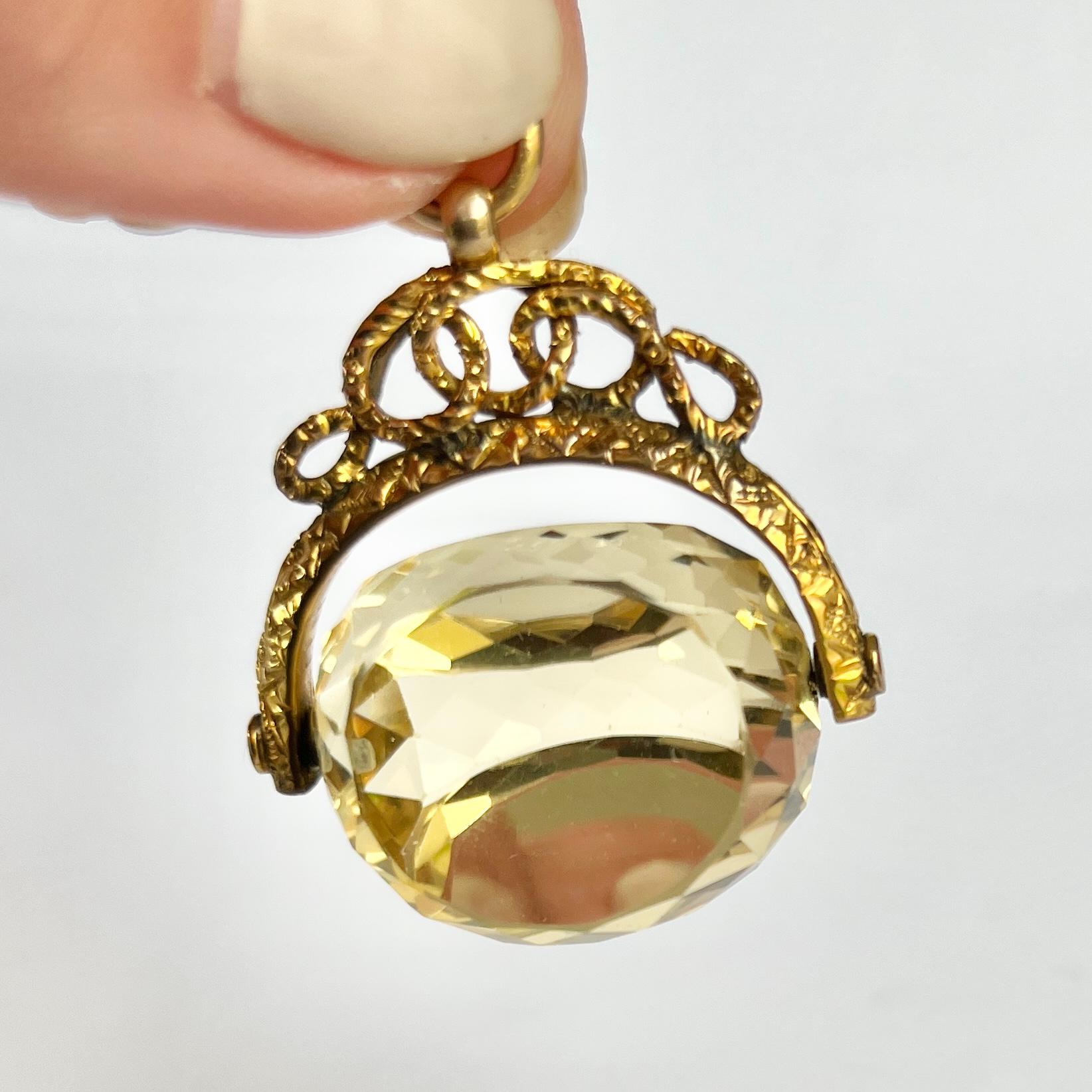 This gorgeous swivel fob holds a yellow citrine stone and the frame and loop is modelled out of 9ct gold. The frame has a snake like feel to it and twists and turns. 

Height including Loop: 40mm

Weight: 15.8g 