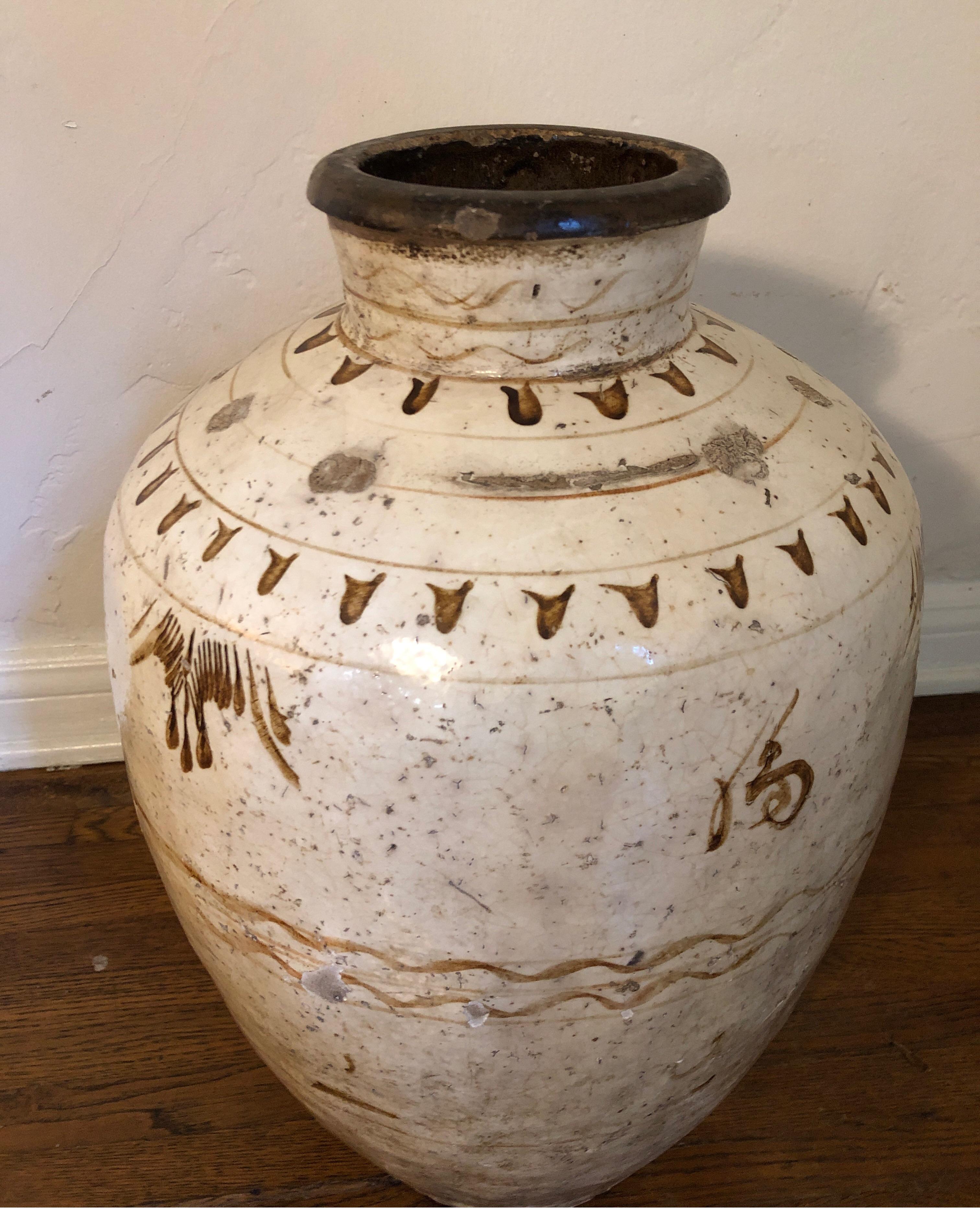 Ming dynasty cizhou vase.
Hand painted tribal motives and calligraphy. Glazed.

Was made into a lamp at one point so has small hole in bottom. See pics.