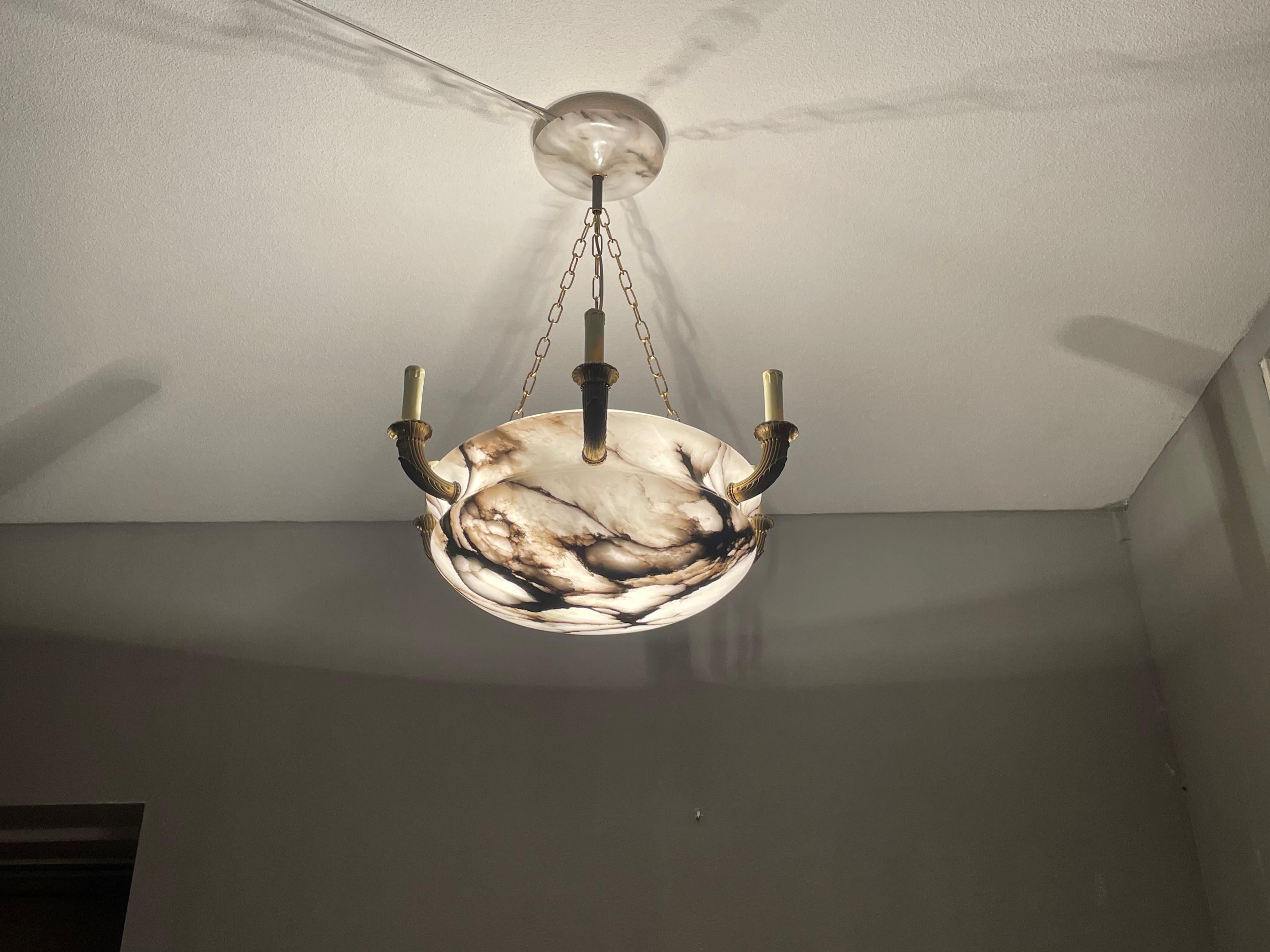 Stunning, eight-light, white & black alabaster chandelier with gilt bronze arms. 

If you are looking for a truly stylish, well proportioned and top quality made antique chandelier then this work of lighting art from the earliest years of the 1900s
