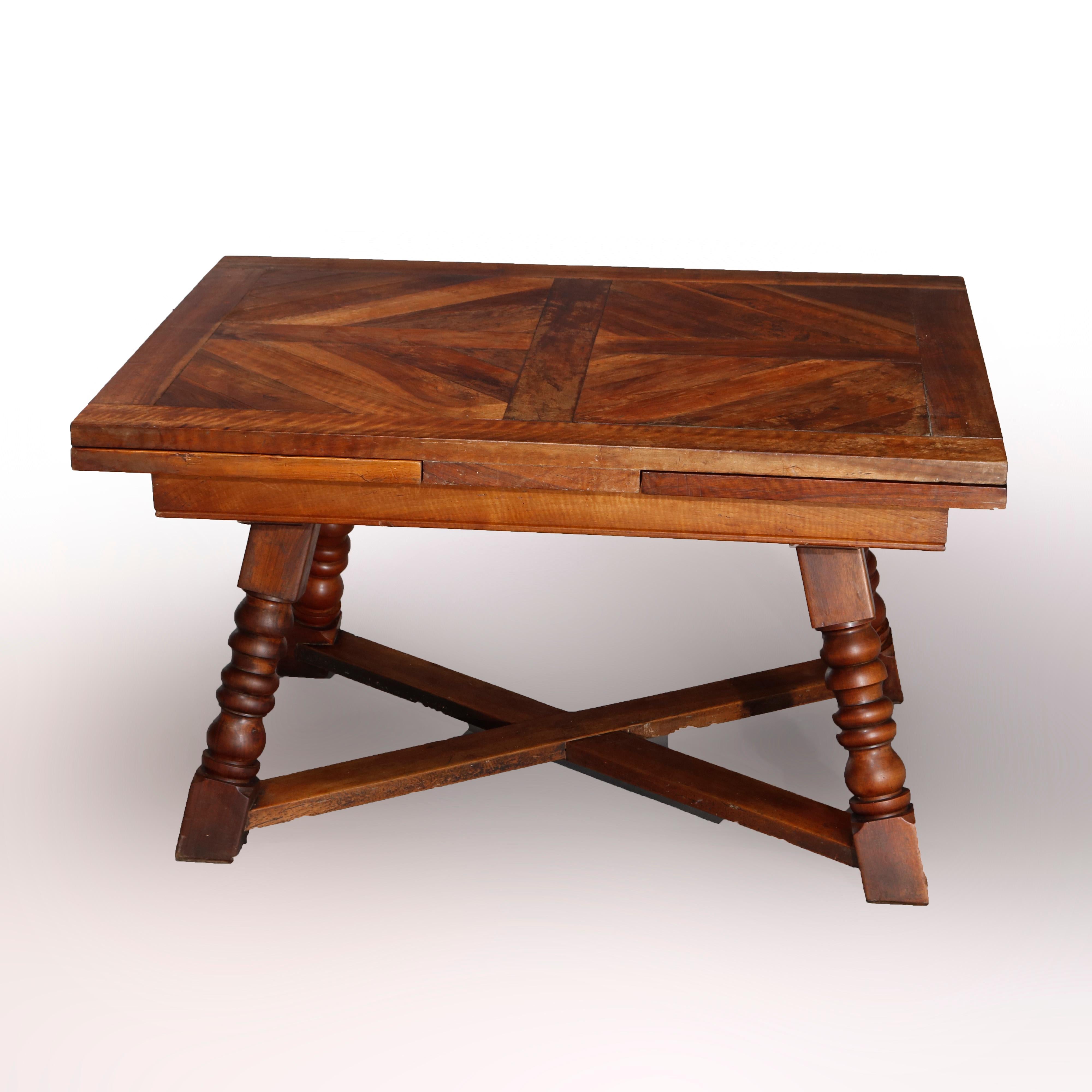 An antique and large continental draw-top dining table offers walnut construction with parquetry inlaid top with two leaves, raised on splayed turned legs having X-stretcher base, 19th century

Measures: 29.25