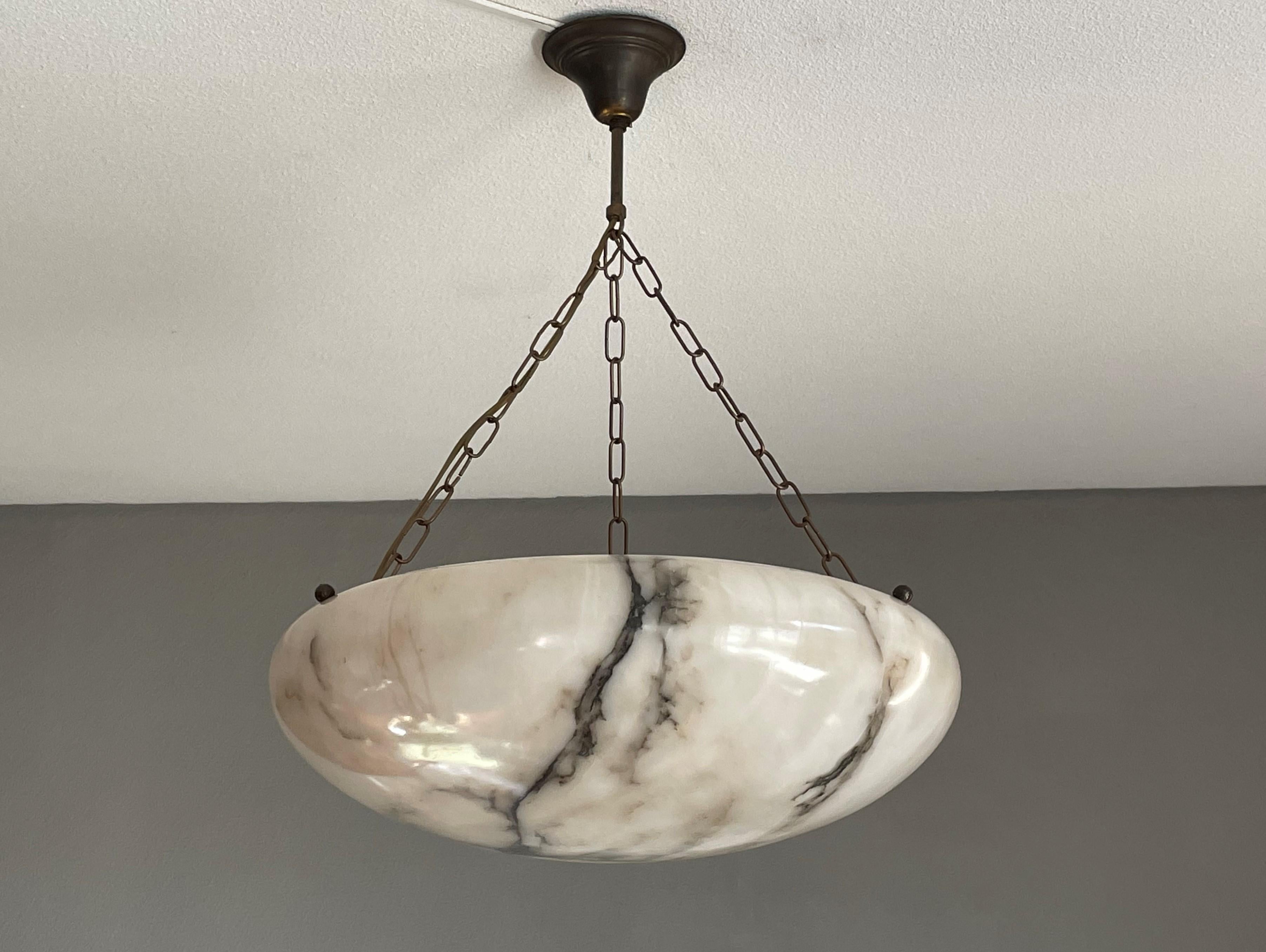 Top class and timeless chandelier with a stunning and rare size alabaster shade.

Thanks to its large size, very good condition and timeless design this alabaster pendant or flush mount is the perfect lighting solution for many types of rooms and