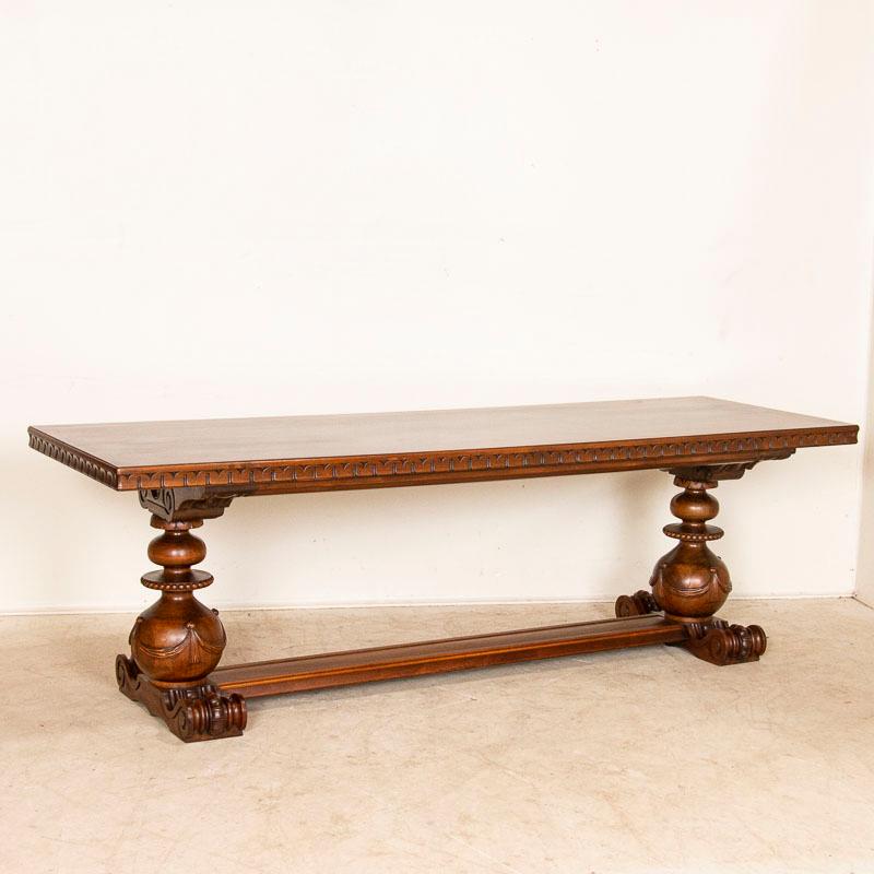 This impressive library or refectory table is visually stunning due to the excellent craftsmanship revealed in the dramatic rounded legs with carved swag details. Examine the photos to appreciate the 