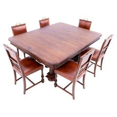 Antique, large dining table with chairs, Western Europe.