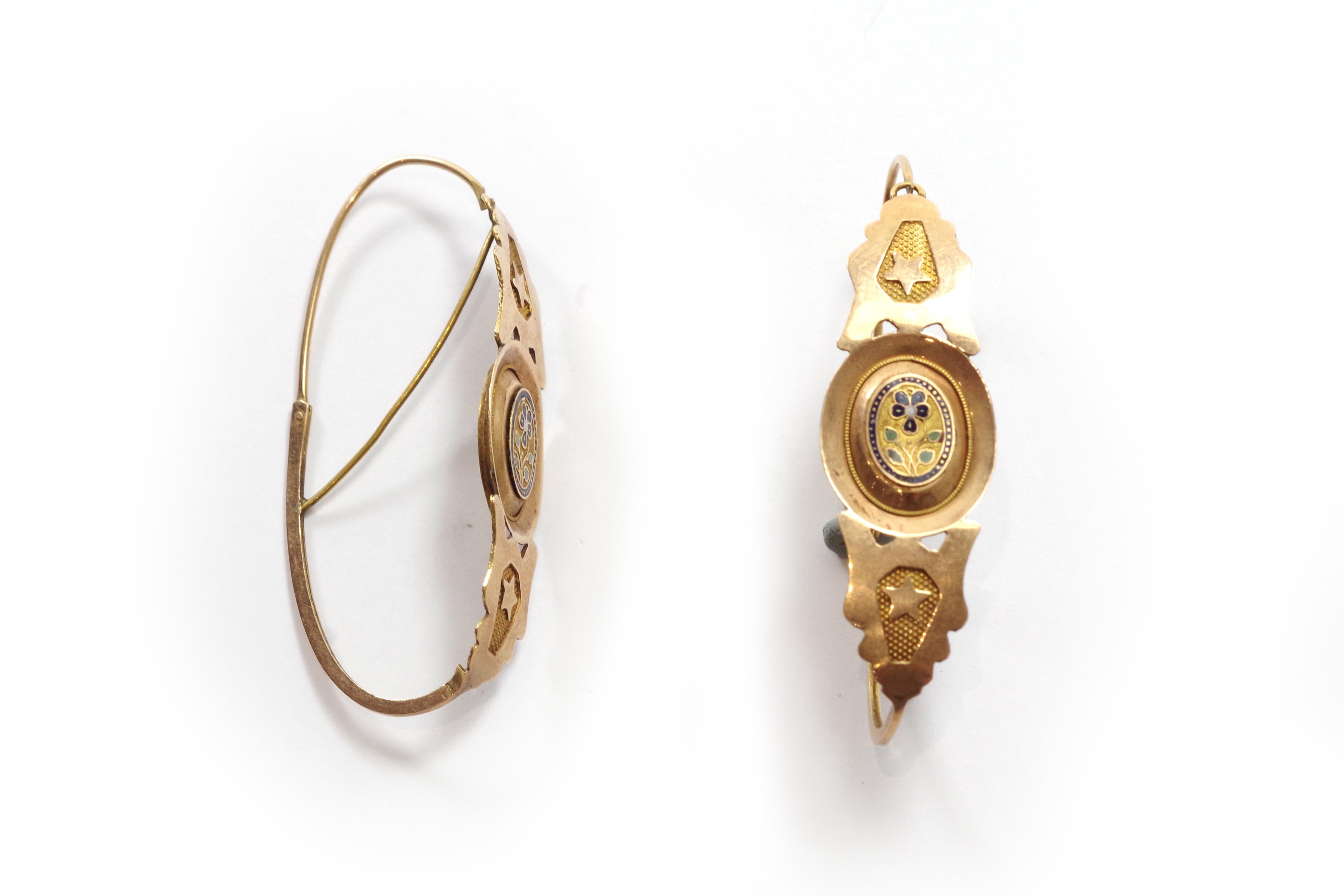Large enameled poissardes earrings in 18 karat rose gold. These substantial poissarde earrings are centered with a blue, green, and white enameled pansy, surrounded by a midnight blue enamel frieze punctuated with gold dots. The main motif is framed